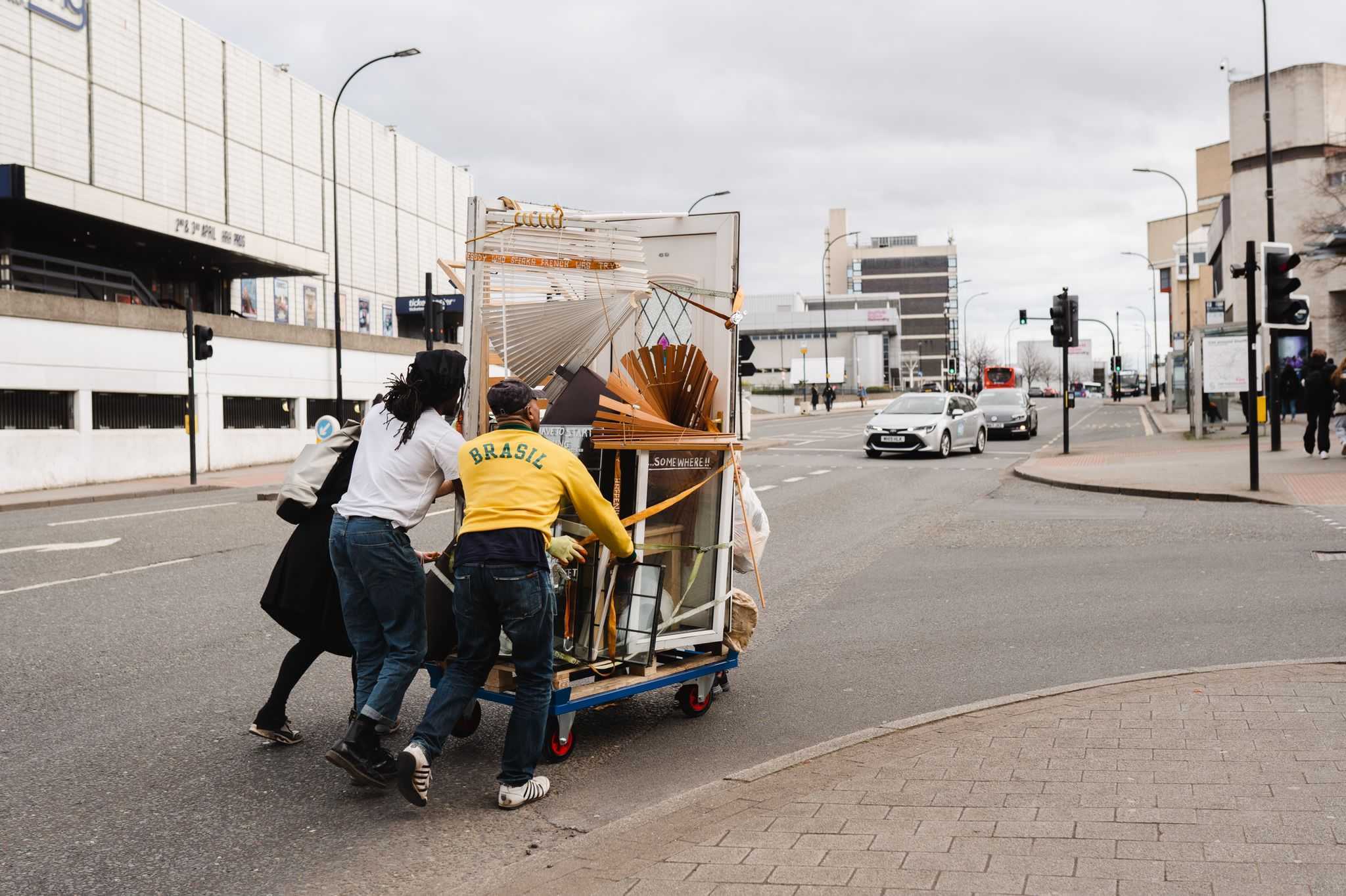 Resolve Collective members Seth and Akil Scafe-Smith and Melissa Haniff pushing a trolley of discarded materials