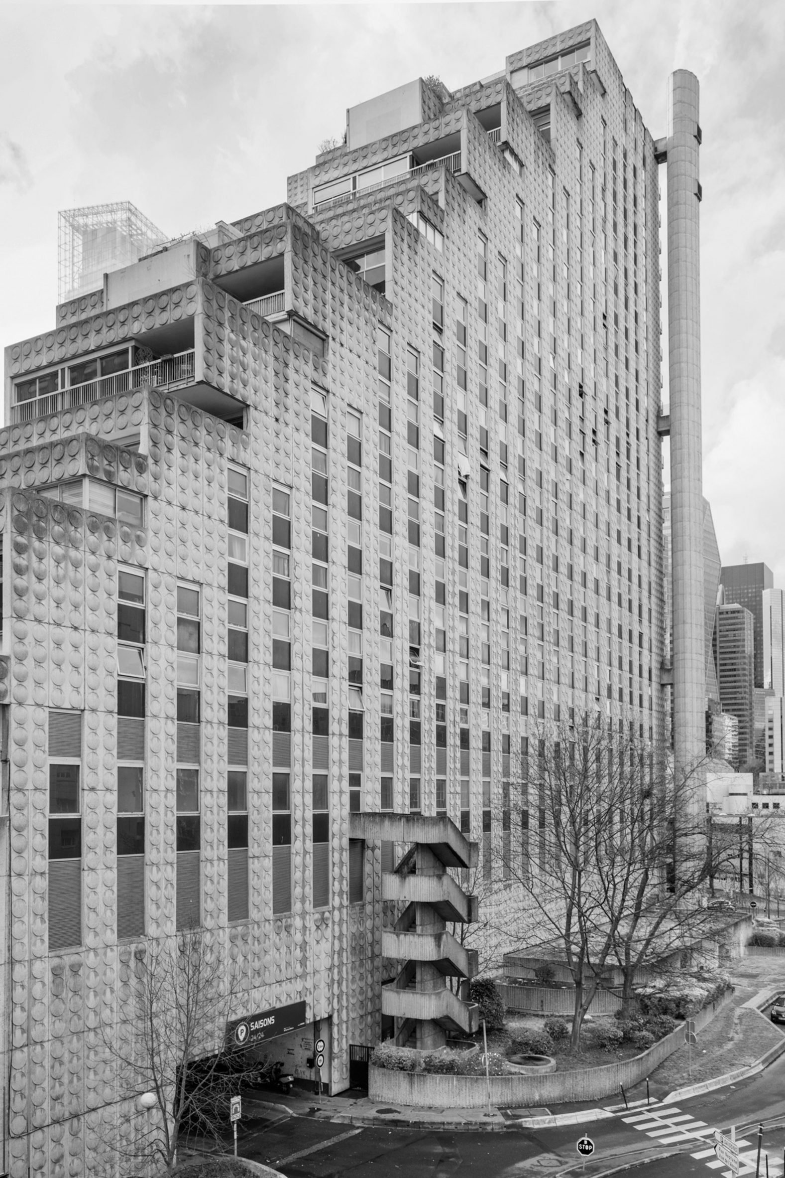 Black and white photo of a brutalist concrete tower with a stepped roof