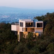 Casa Ventura emerging from the forested hillside