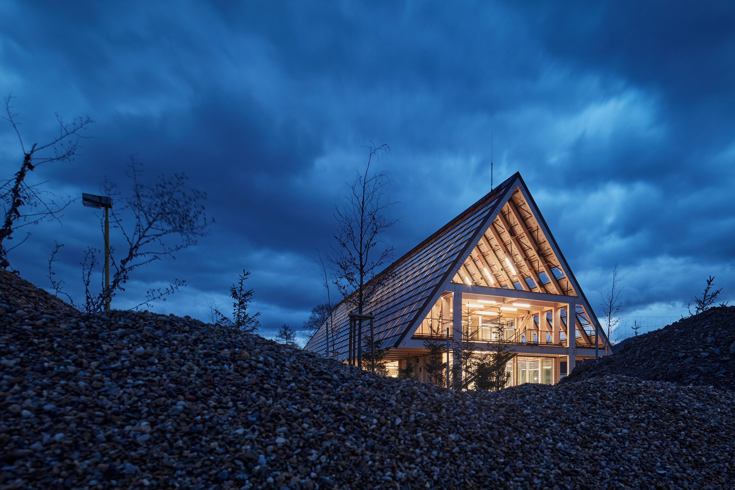Nighttime view of Kloboucká lesní HQ by Mjölk Architekti