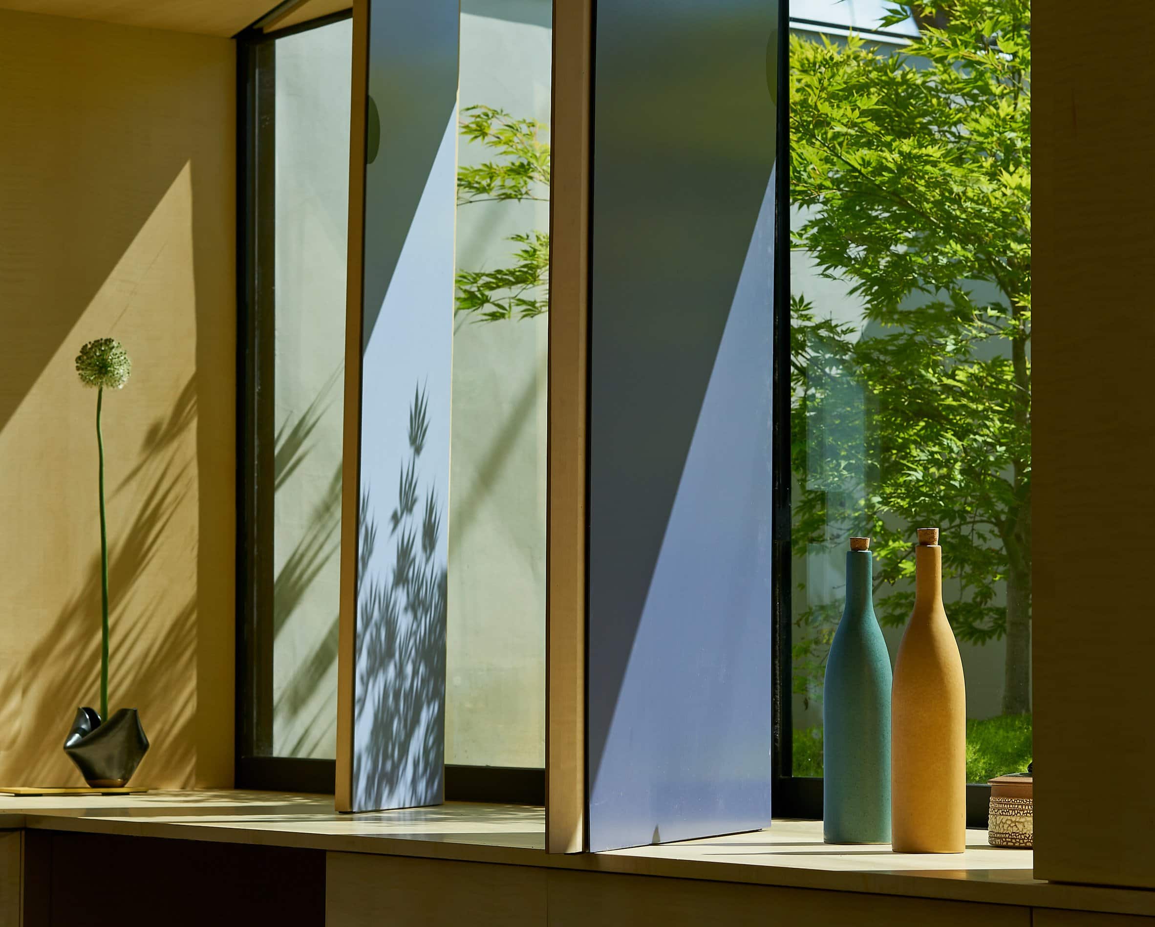 Pivoting desk panels designed in blue, with shadows cast on them, by Neal Schwartz