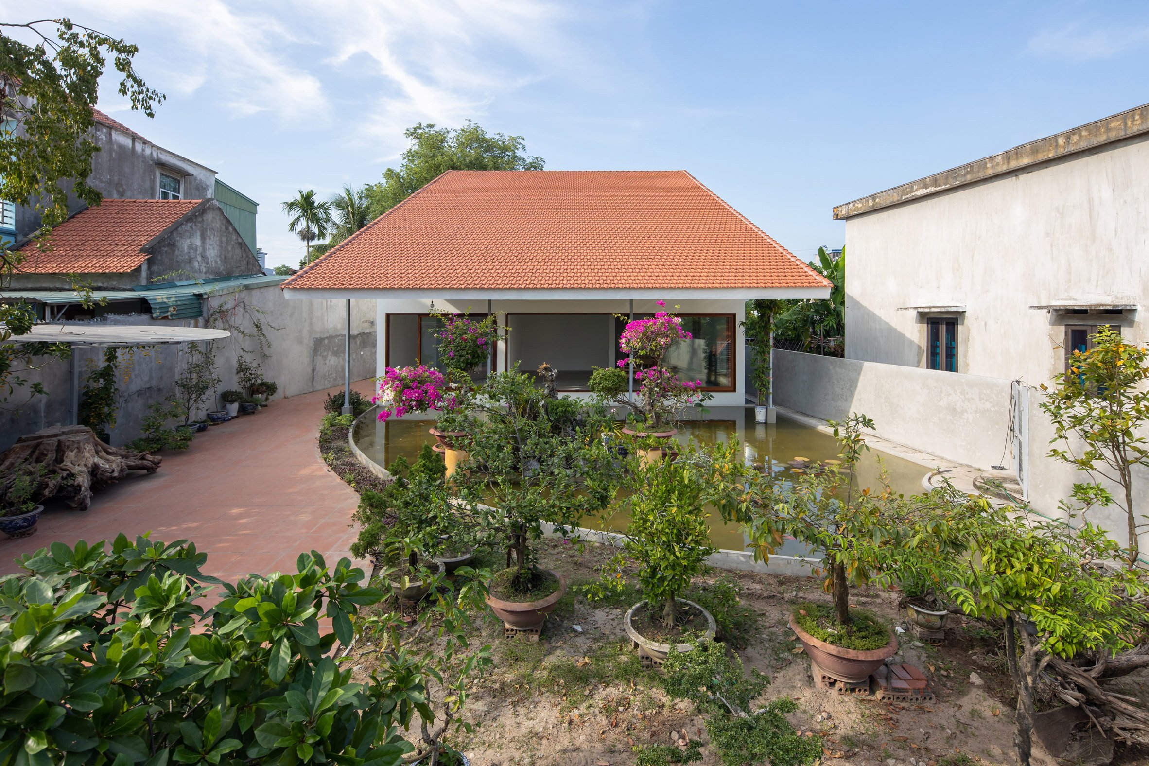 Exterior of House in Quang Yen with a terracotta-tiled roof and planted garden