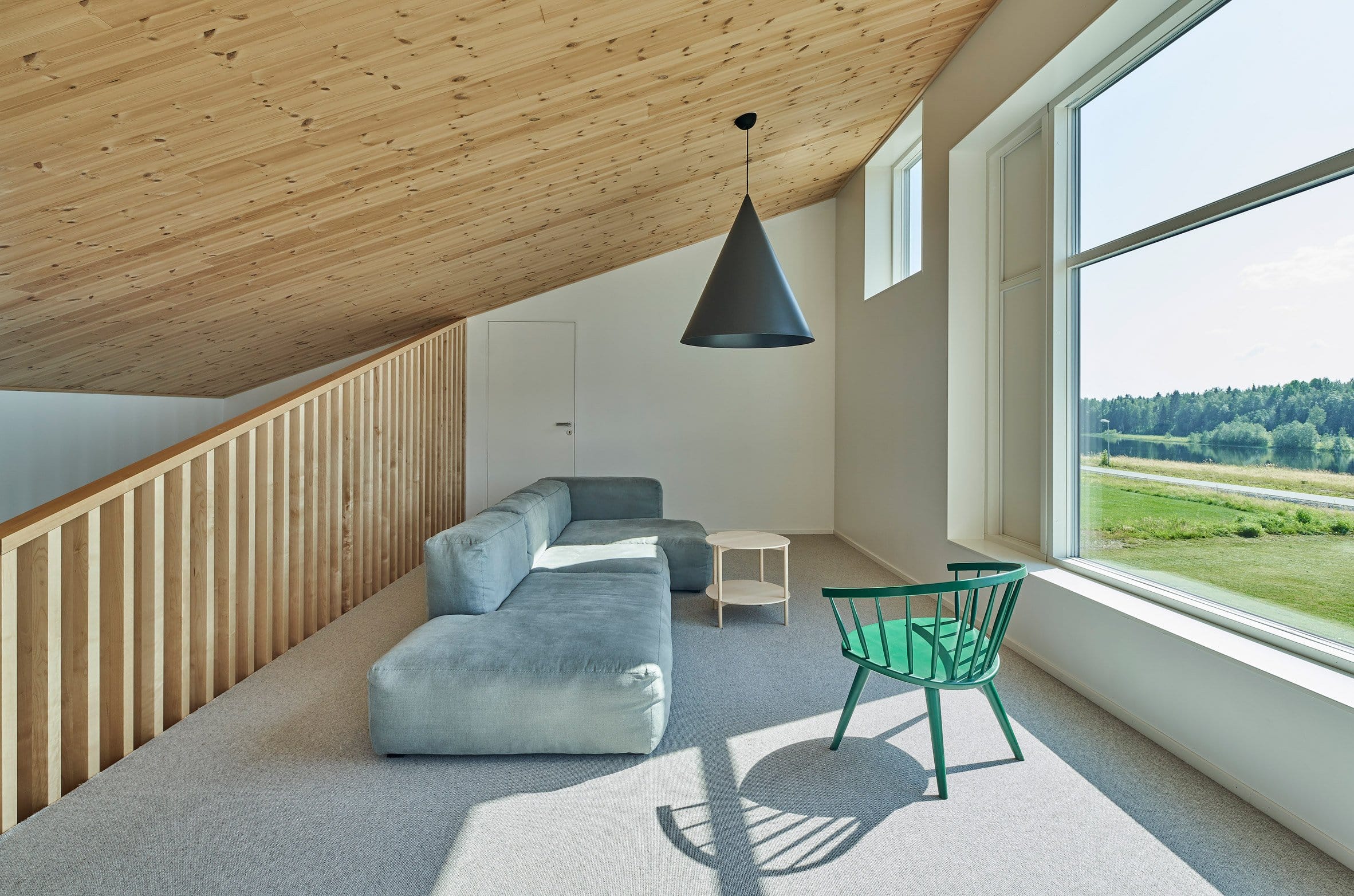 Living room with sloped wood-lined ceiling