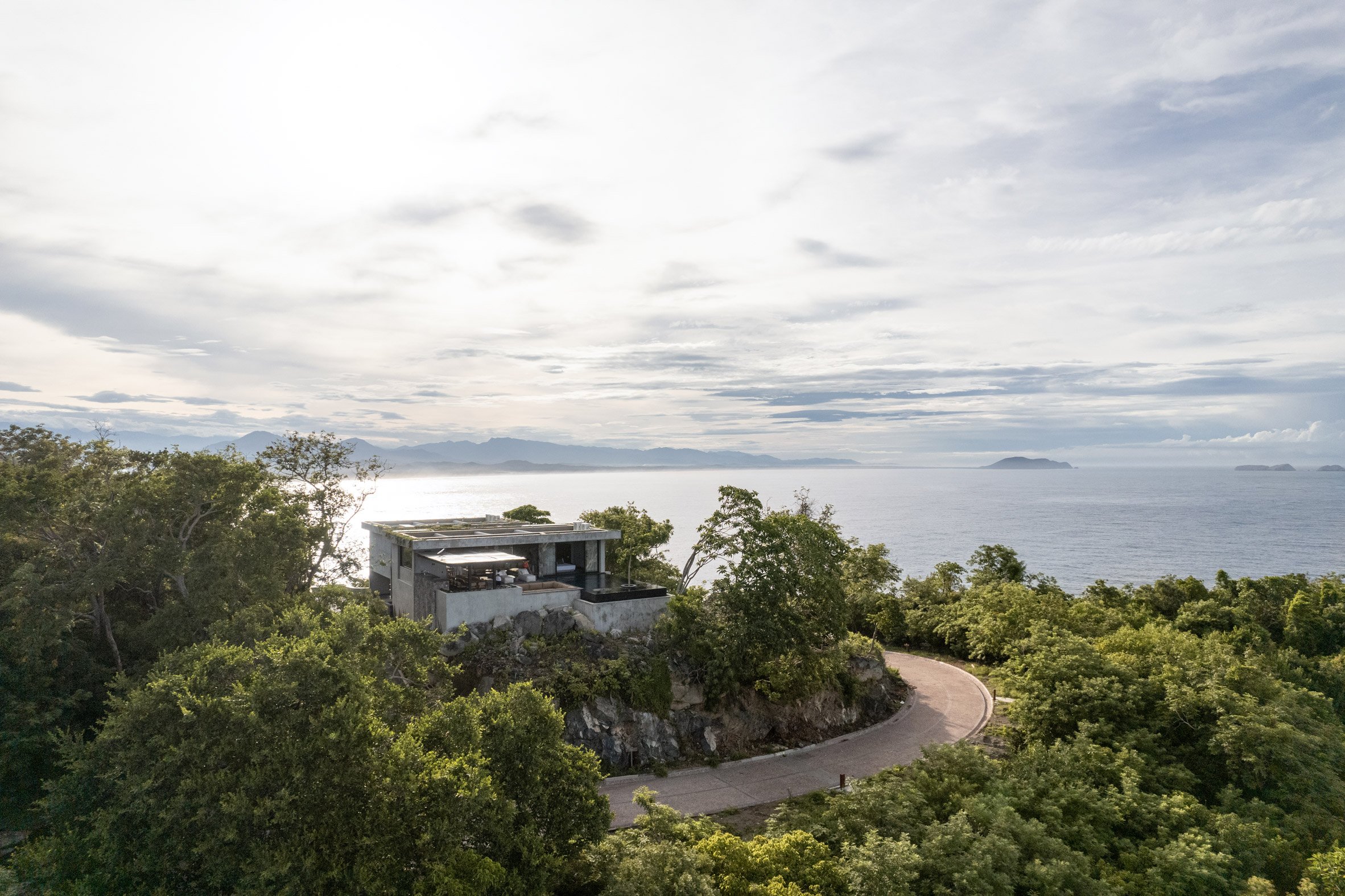 Rectilinear concrete house positioned on a site above the Pacific coast of Mexico