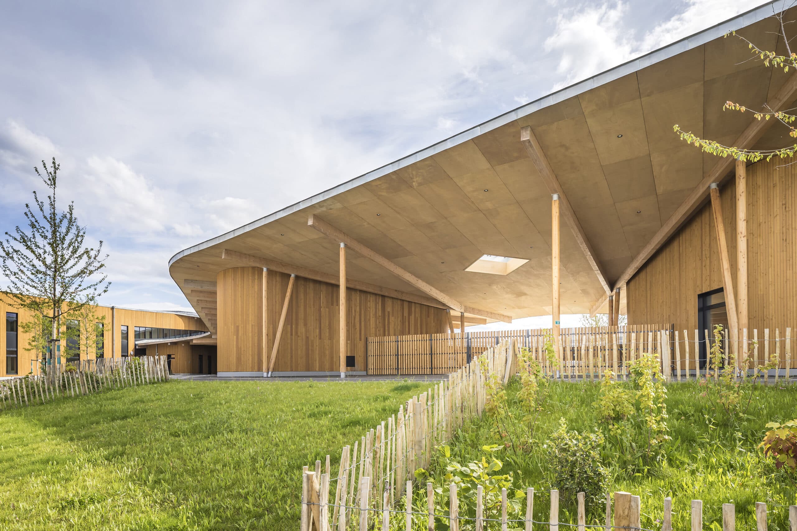 A shot of the courtyard facing the building's inner facade, showcasing its stunning wooden cladding.