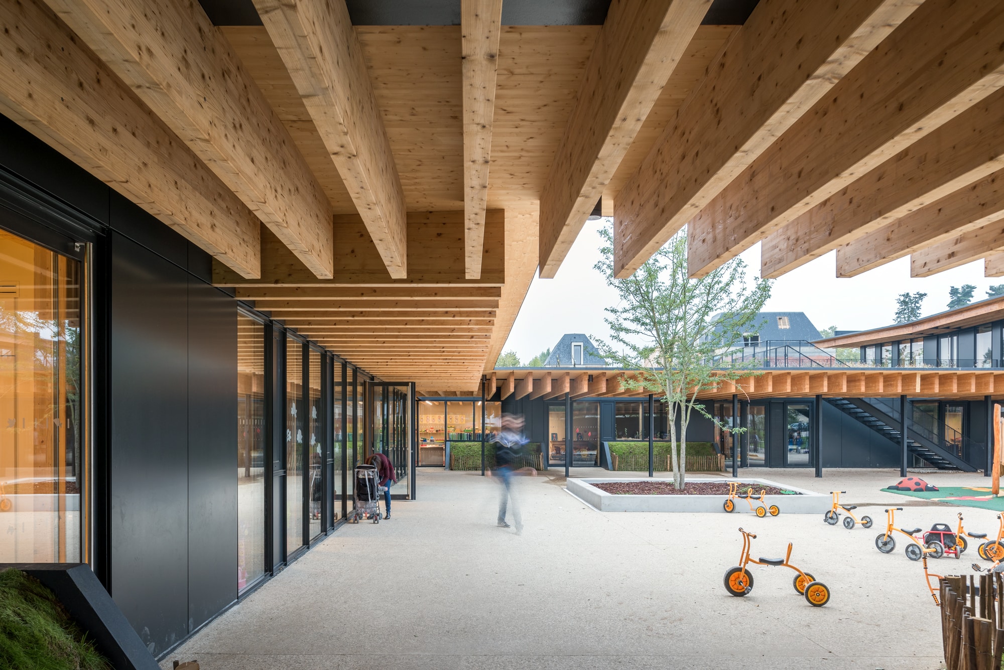 A view towards the inner courtyard, highlighting the stunning wooden ceiling adorned with beams, creating a rustic and warm atmosphere.