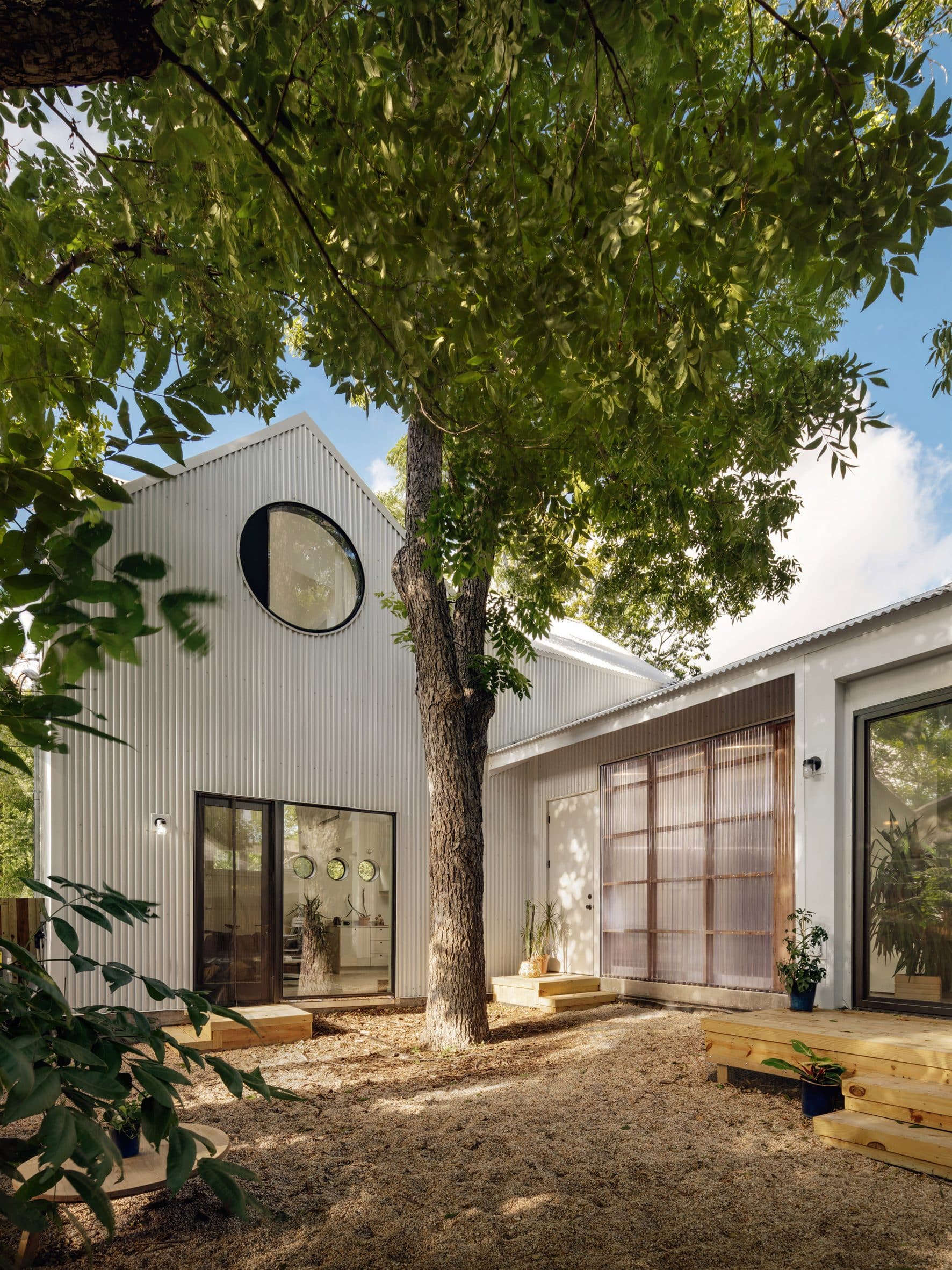 Corrugated metal structure with circular openings and a gabled roof