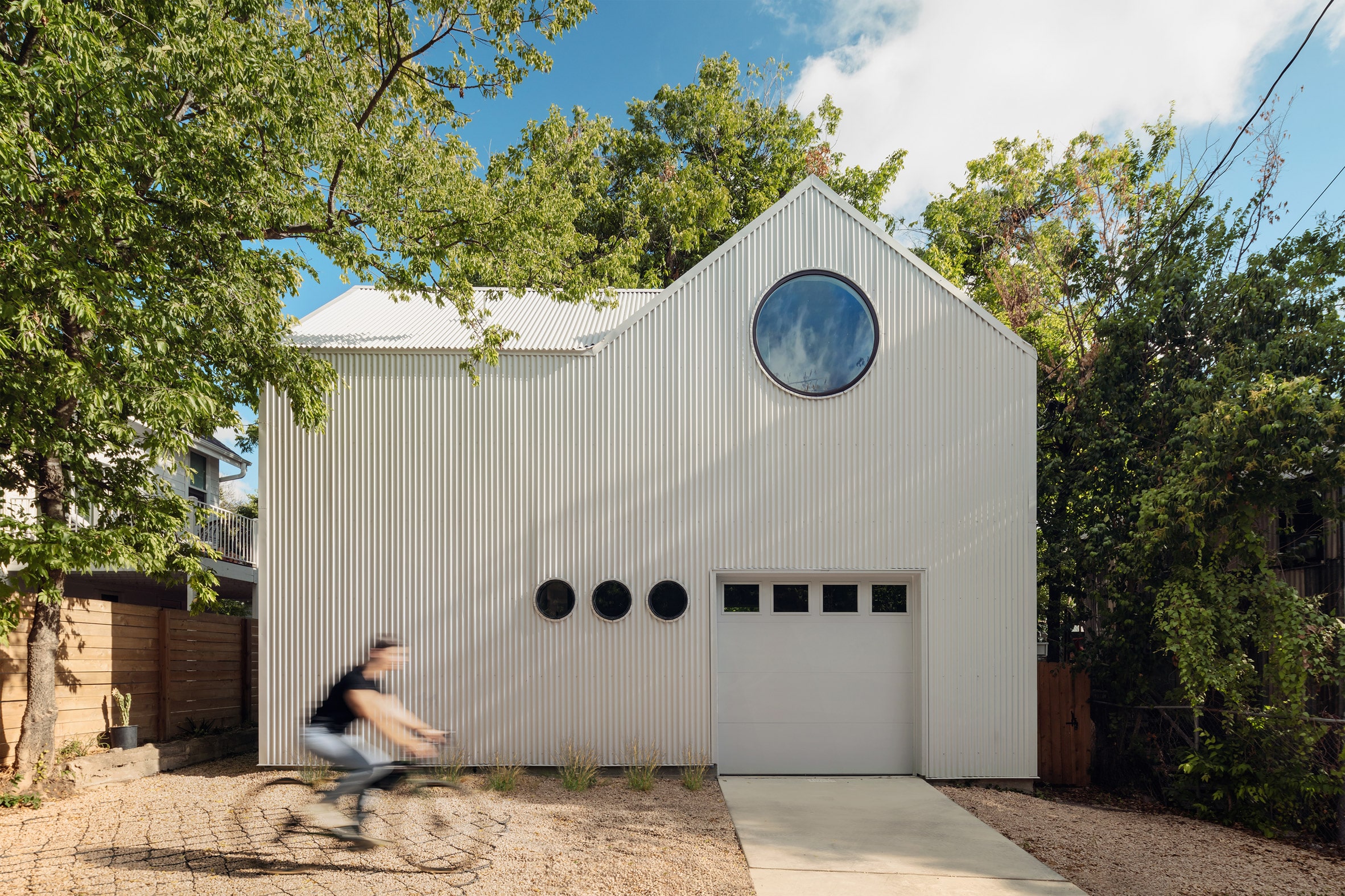 Corrugated metal accessory dwelling unit with a circular window