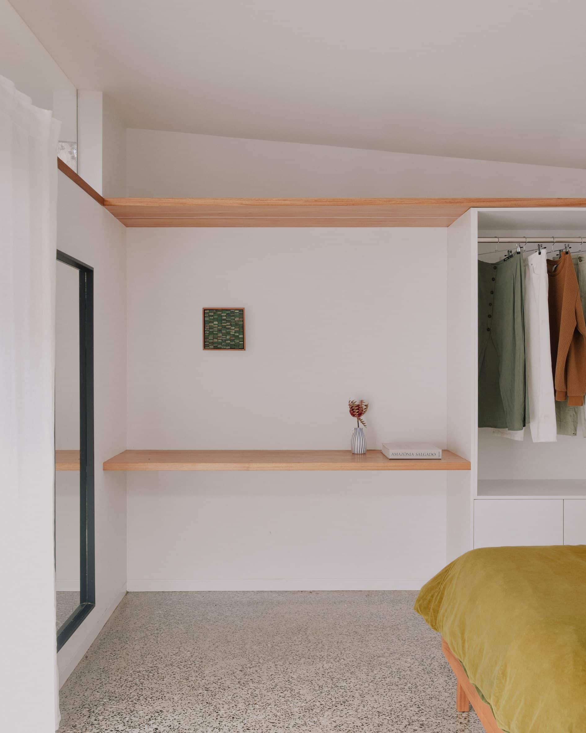 White bedroom with polished concrete floor
