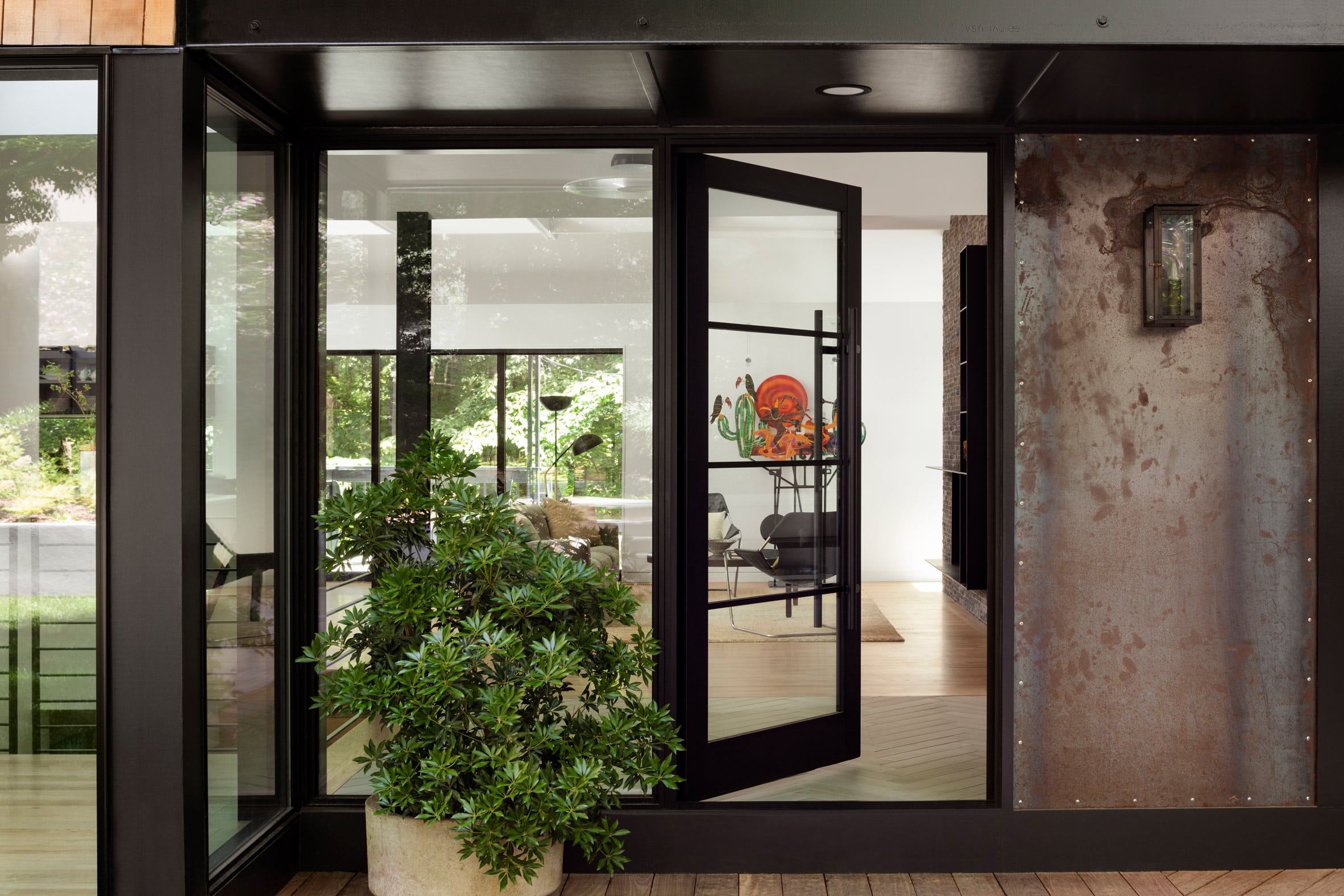 Door to the interior with shrub