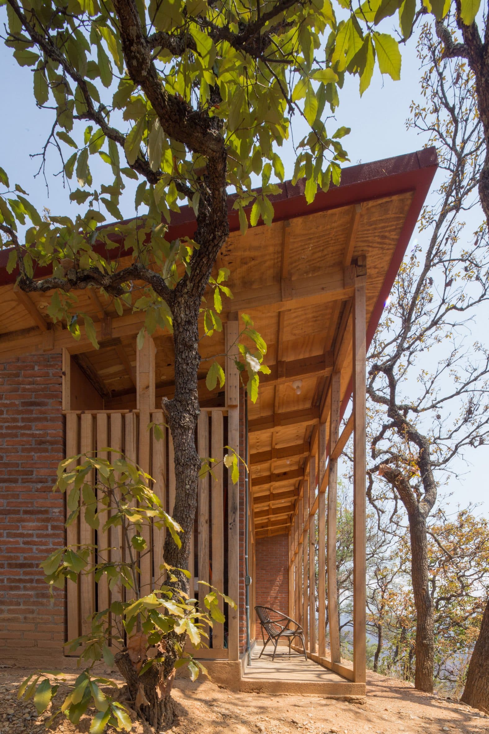 Wooden one-storey home with a mono-pitched roof and porch