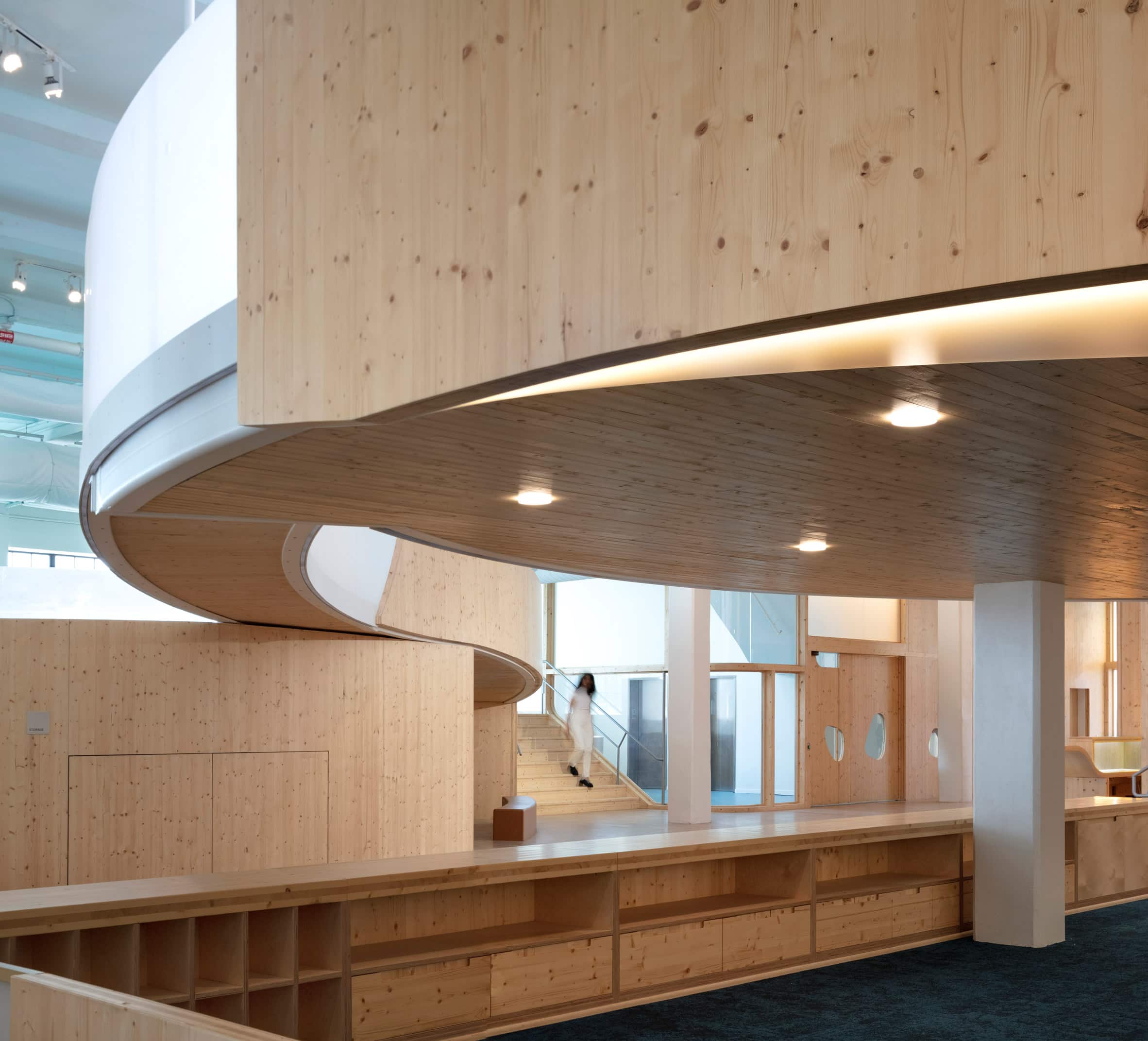 Museum interior with wooden storage and overhead wood walkway