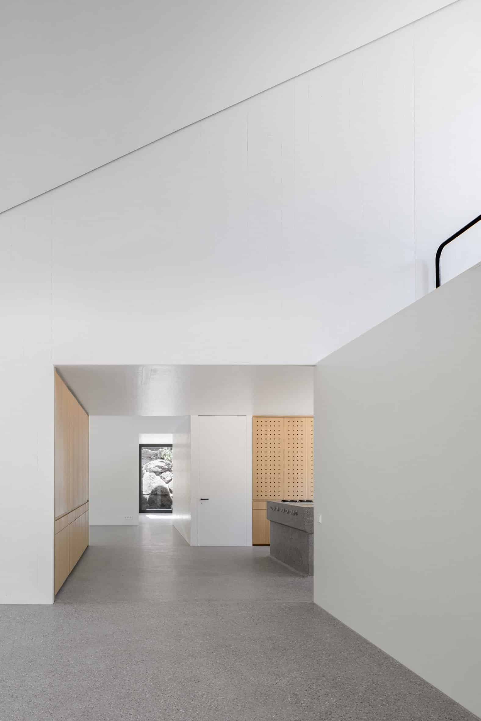 White-walled interior of Wooden House by the Lake by Appels Architekten