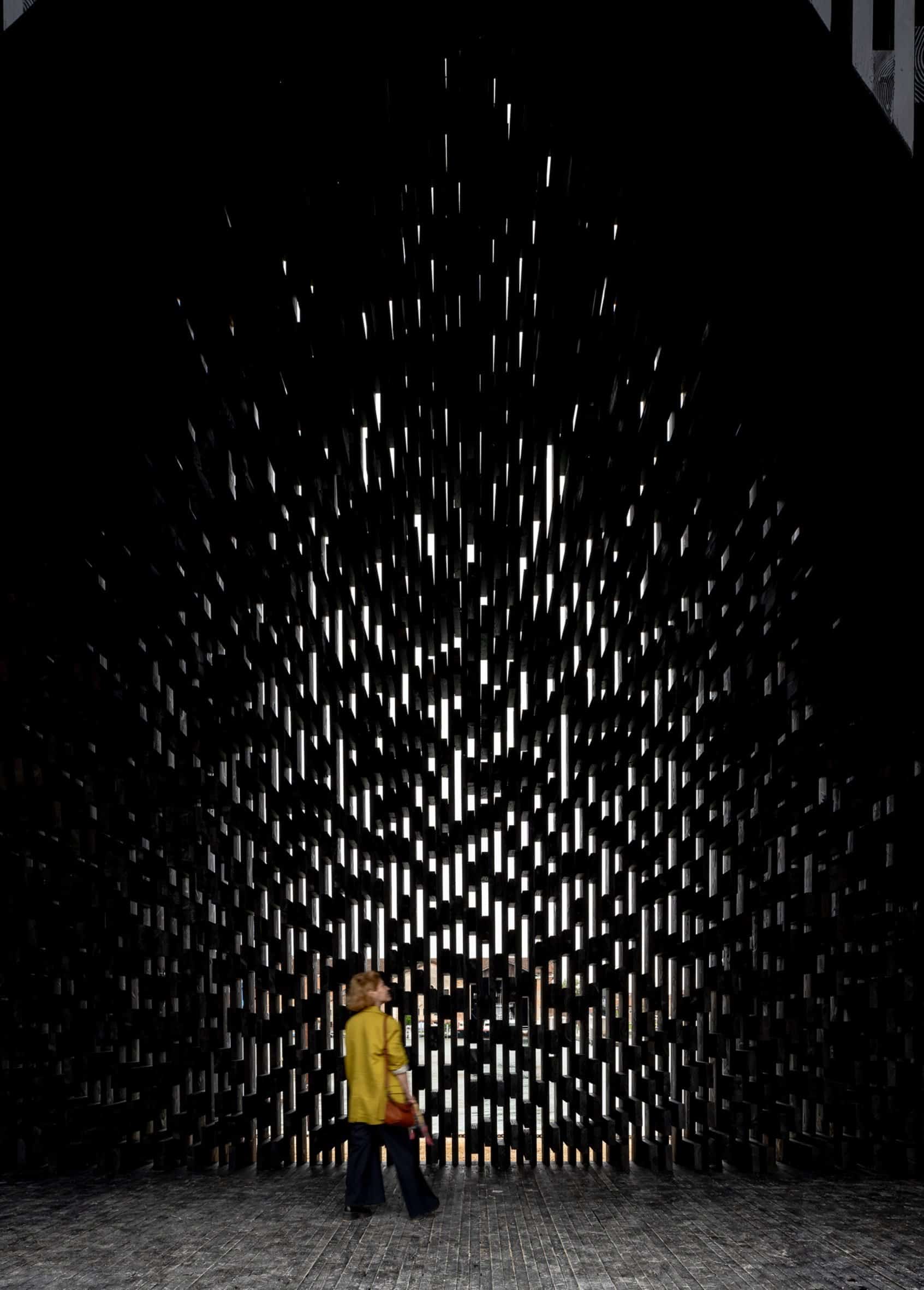 Person inside the Kwaee pavilion at Venice Architecture Biennale