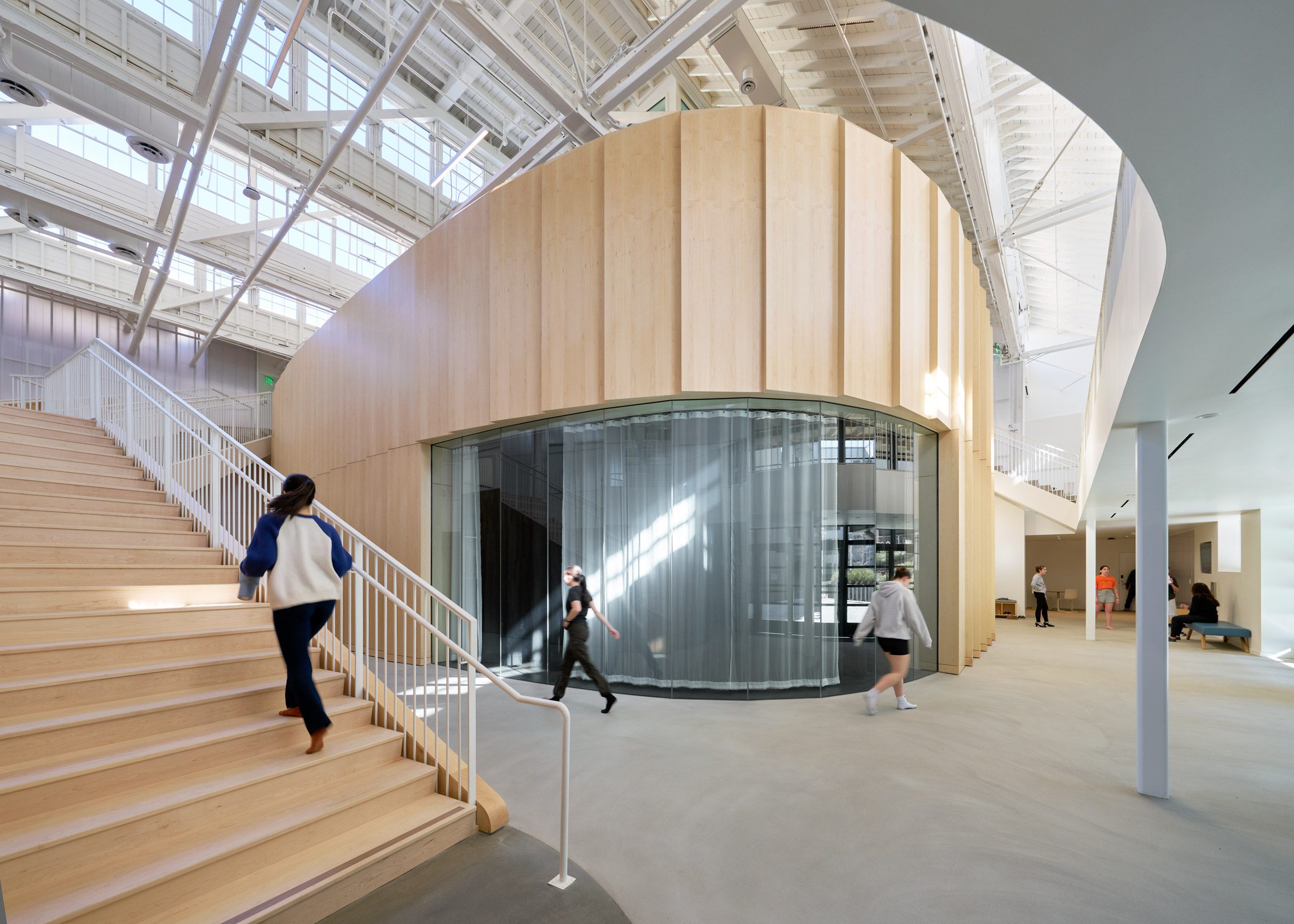 White and wooden interiors within dance school by LOHA