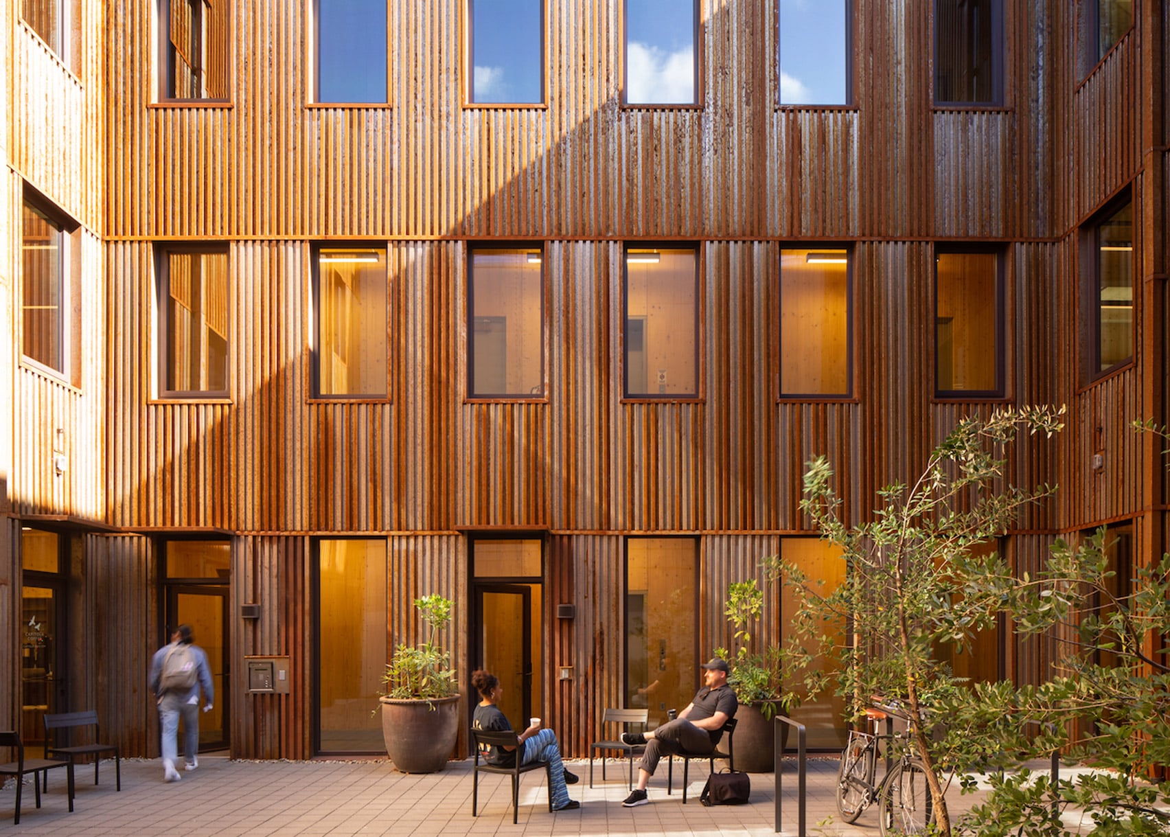 Weathering steel courtyard with people lounging