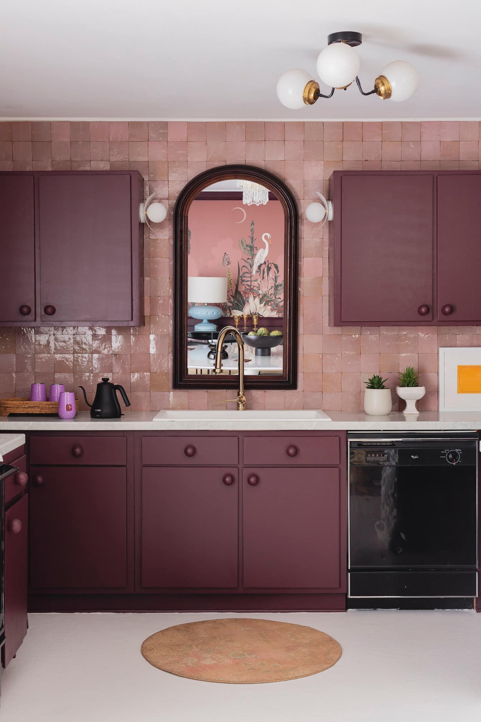Interior of monochrome kitchen with magenta painted kitchen cabinets