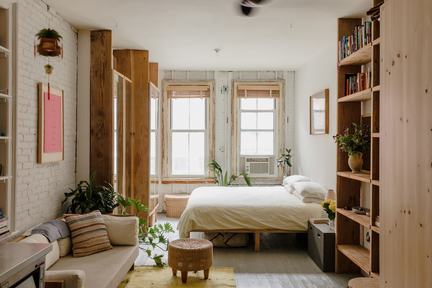 Image may contain Furniture Living Room Room Indoors Bedroom Interior Design Shelf Couch Bed Plant and Cushion