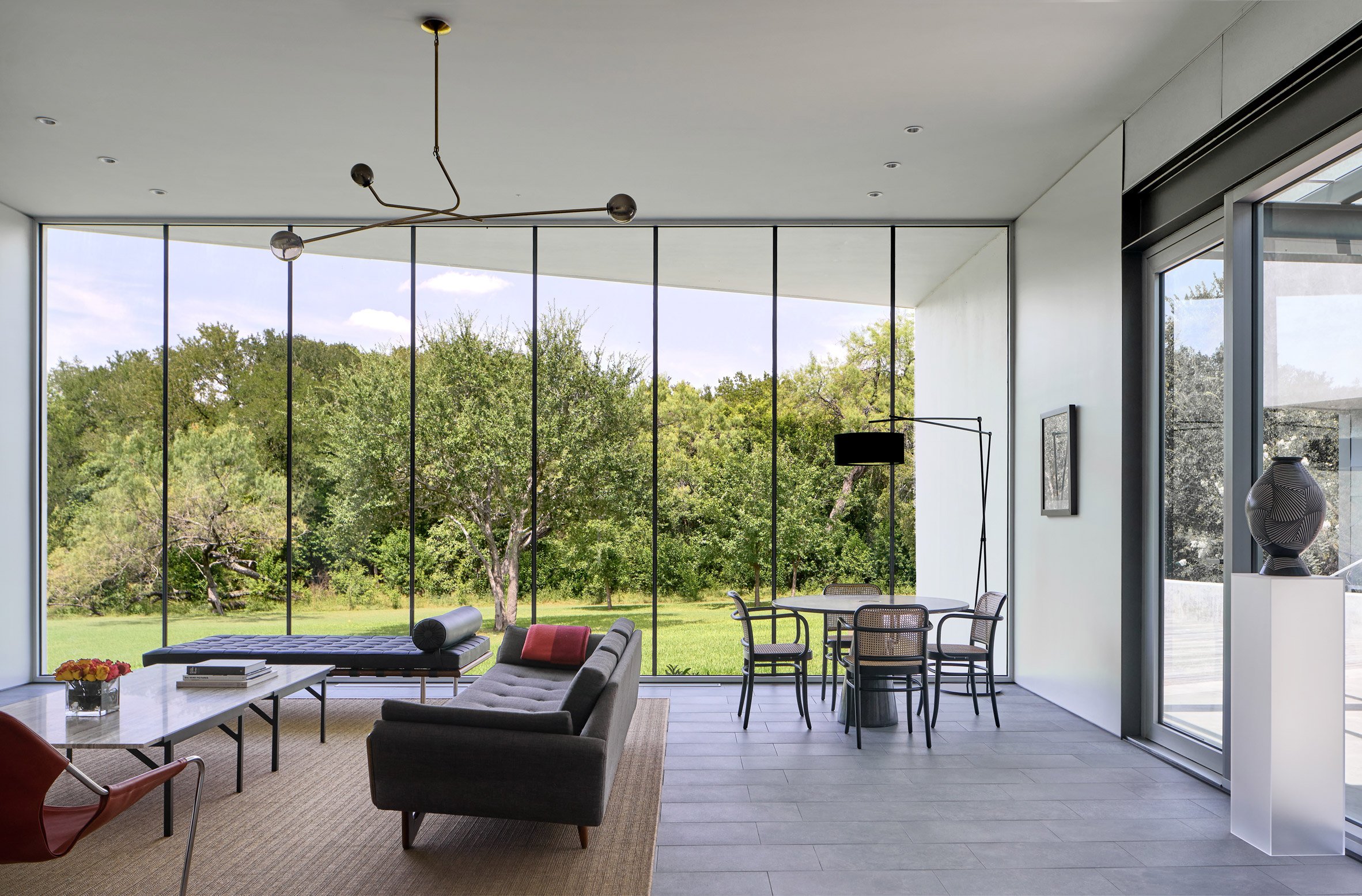 Open -plan living and dining room with floor-to-ceiling windows