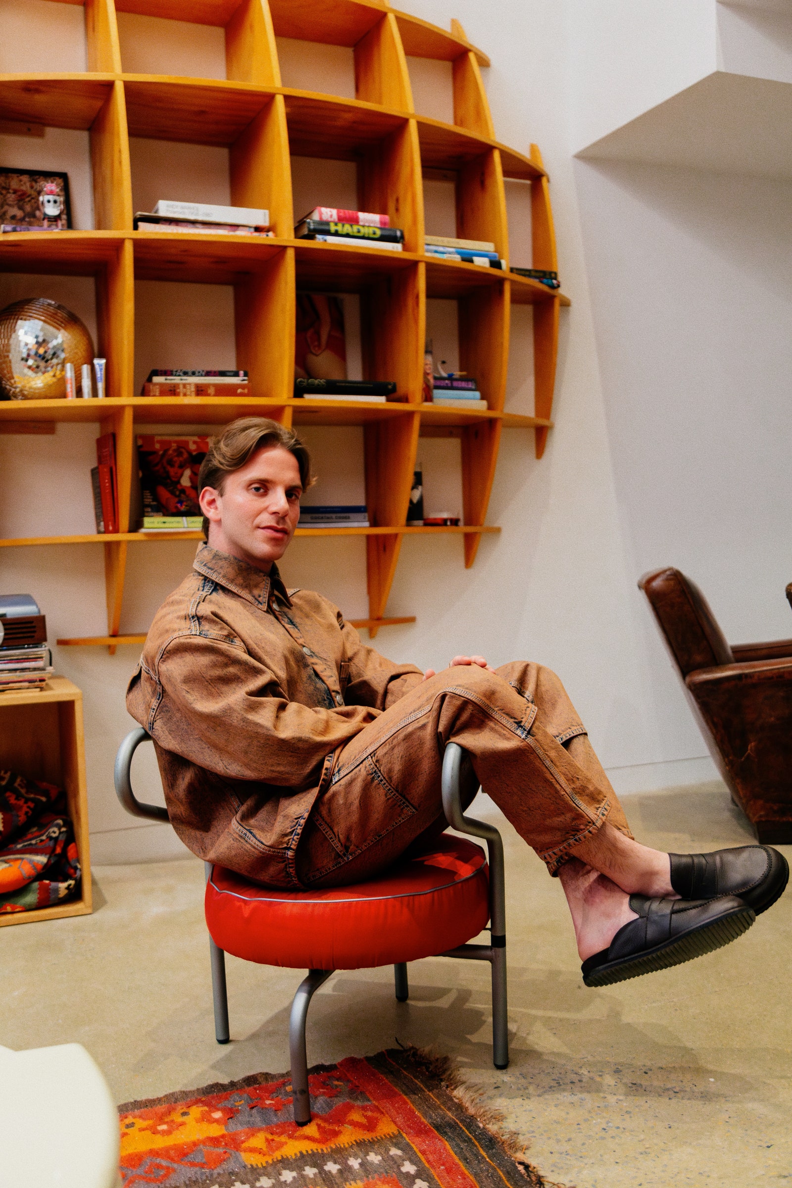 Jonathan perches in his beloved red chair.