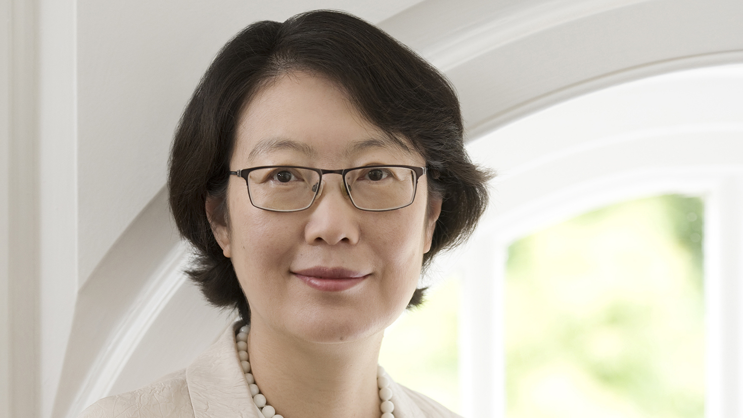 Mugshot of a woman with glasses looking at the camera. Dr Wei Yang has been awarded an OBE at the 2025 New Year Honours.