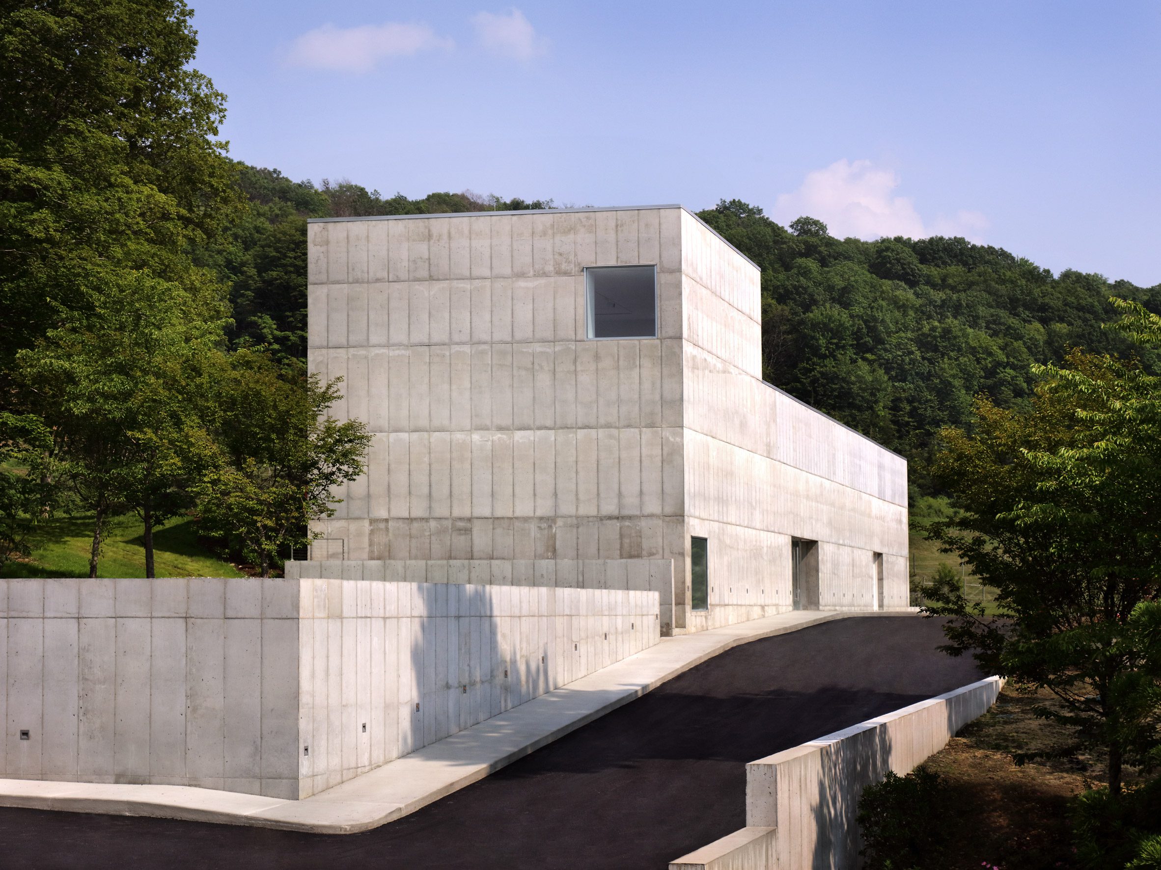 Concrete building with vertical protrusion and square windows