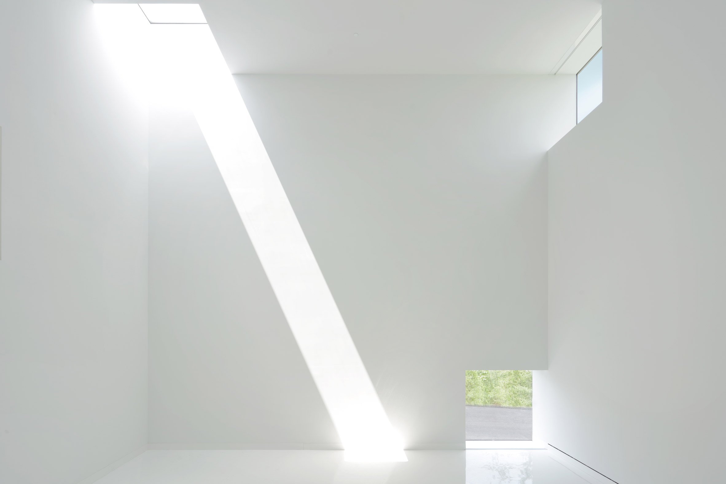 White room with beams of sunlight