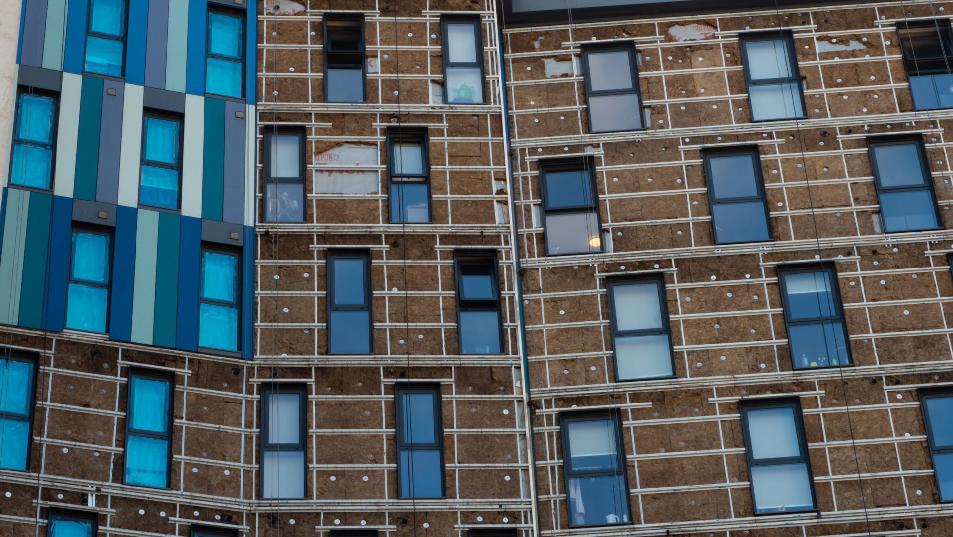 Facade of a building where cladding is being removed