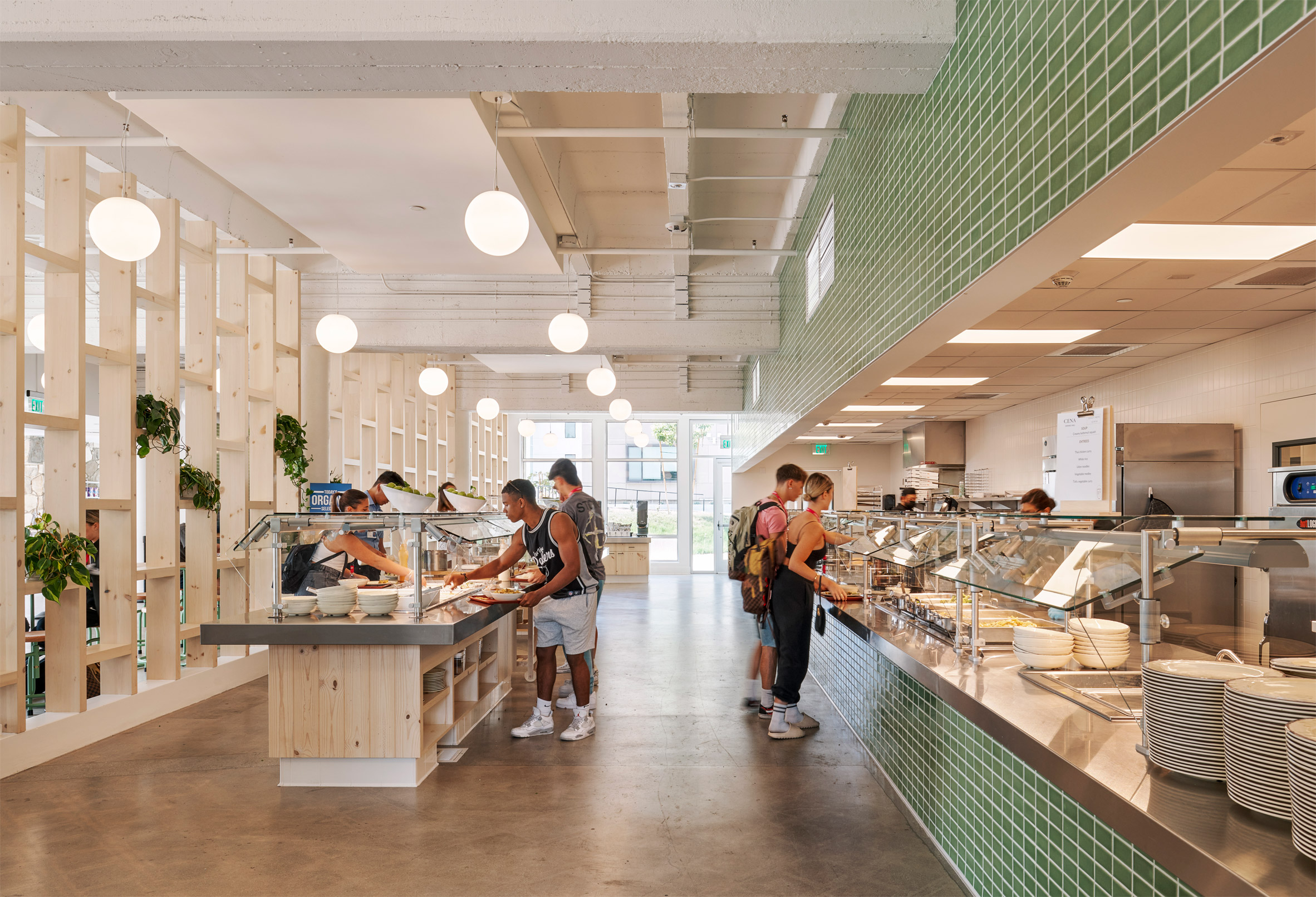 Brightly-lit school canteen with green tiles