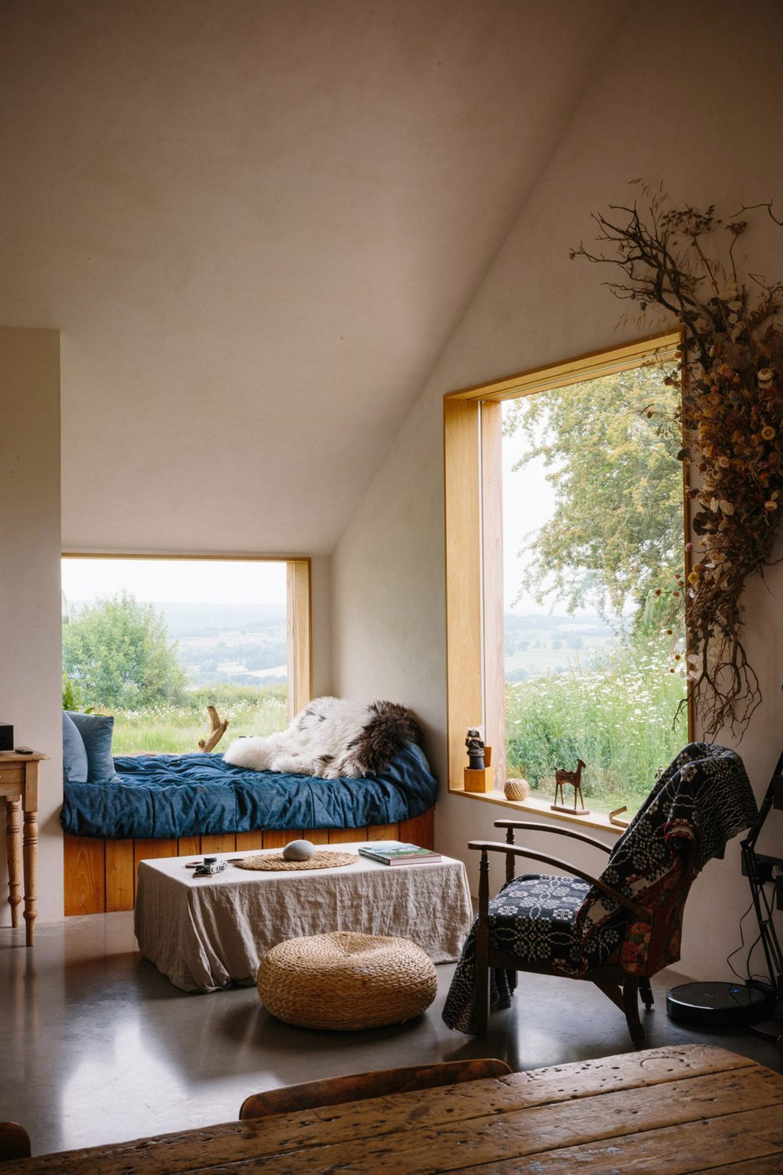 Timber-framed corner window with a seating nook