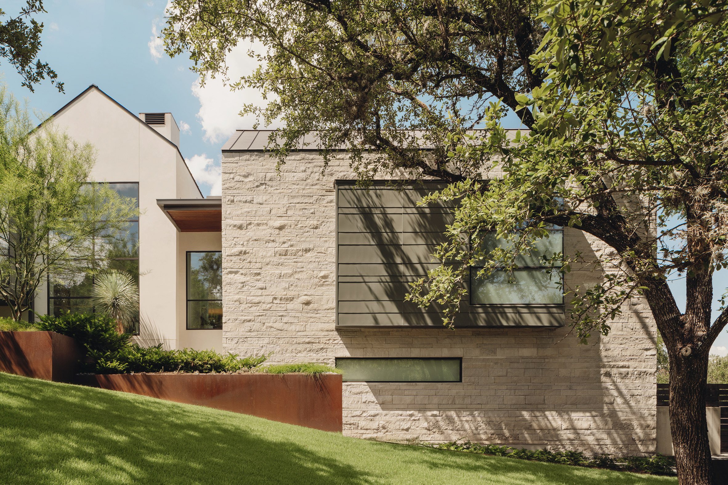 Farmhouse-style home with gabled roof by LaRue Architects