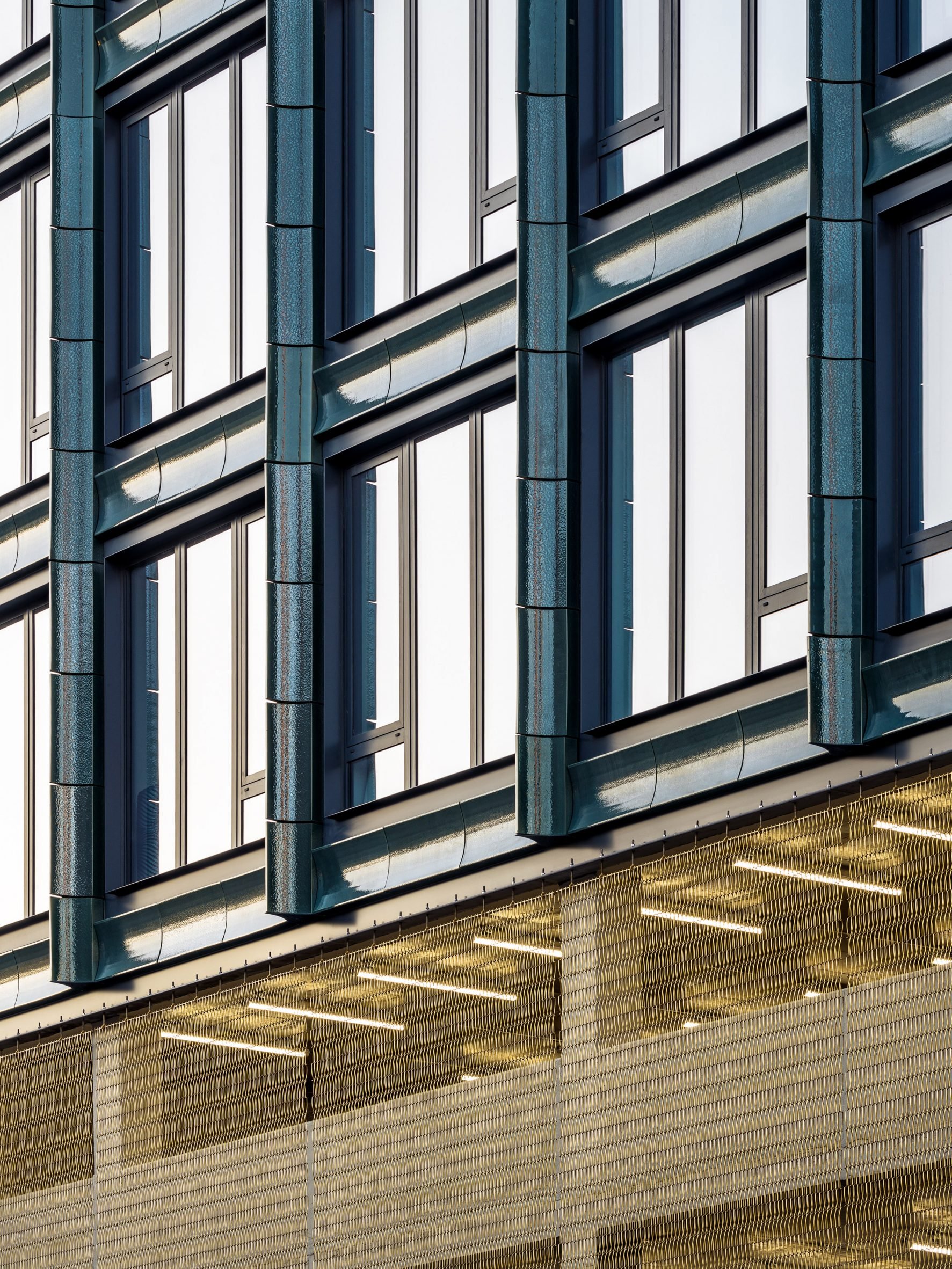 Terracotta tile and bronze mesh facade