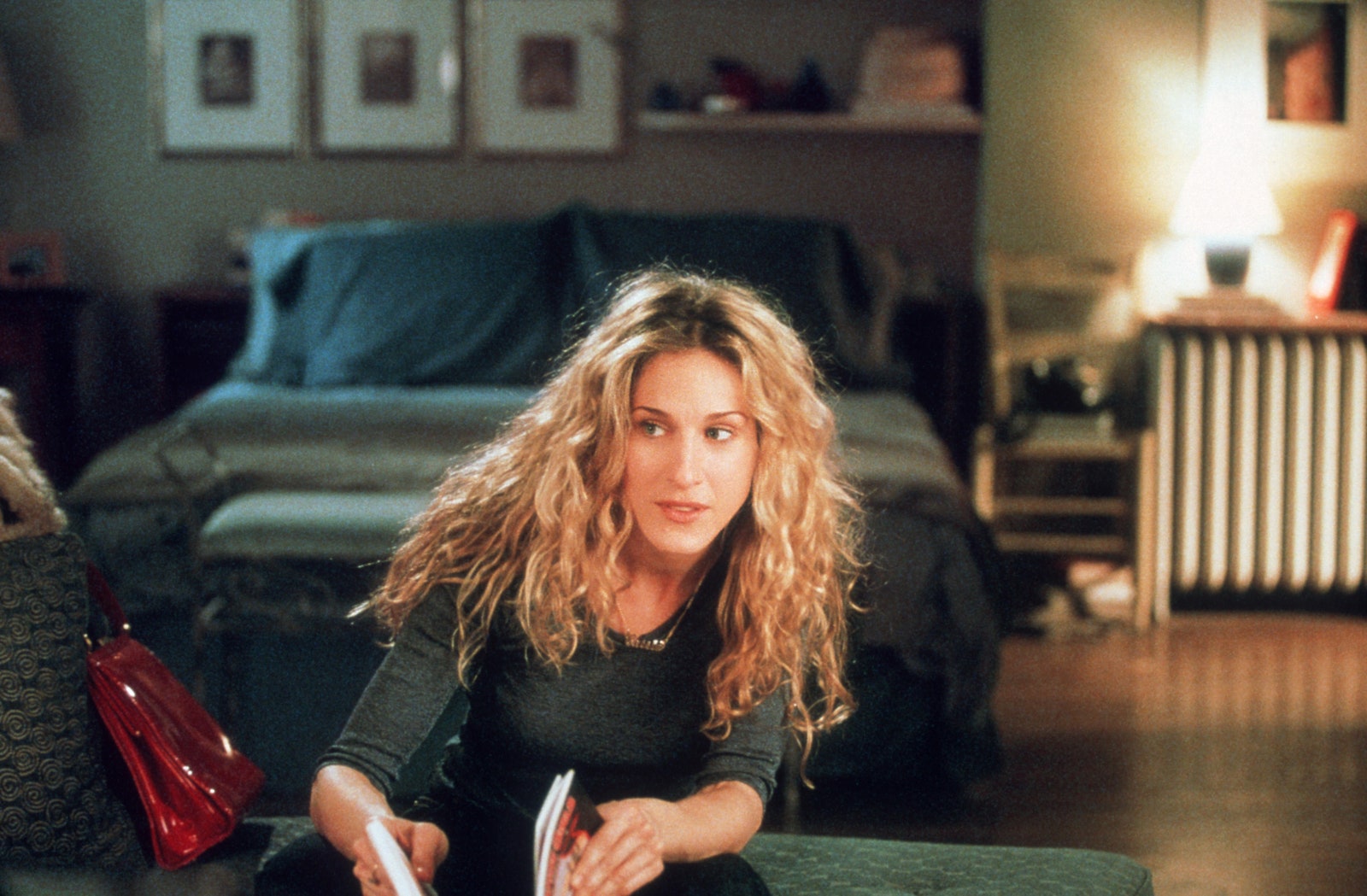 The triptych of photographs above Carries bed is a staple of her apartment decor.