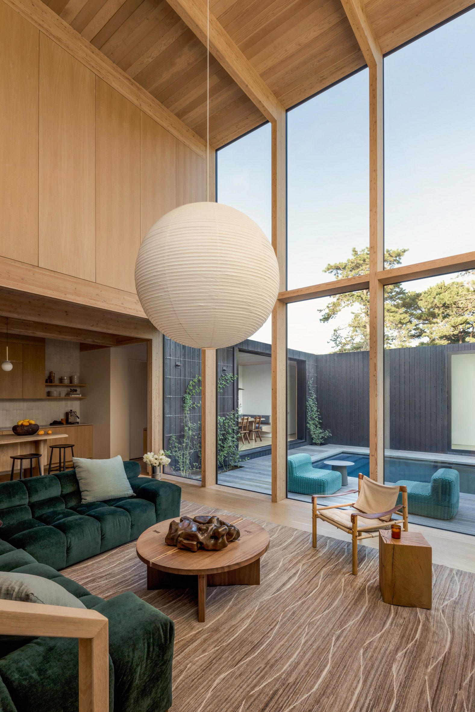 Double-height living room facing swimming pool