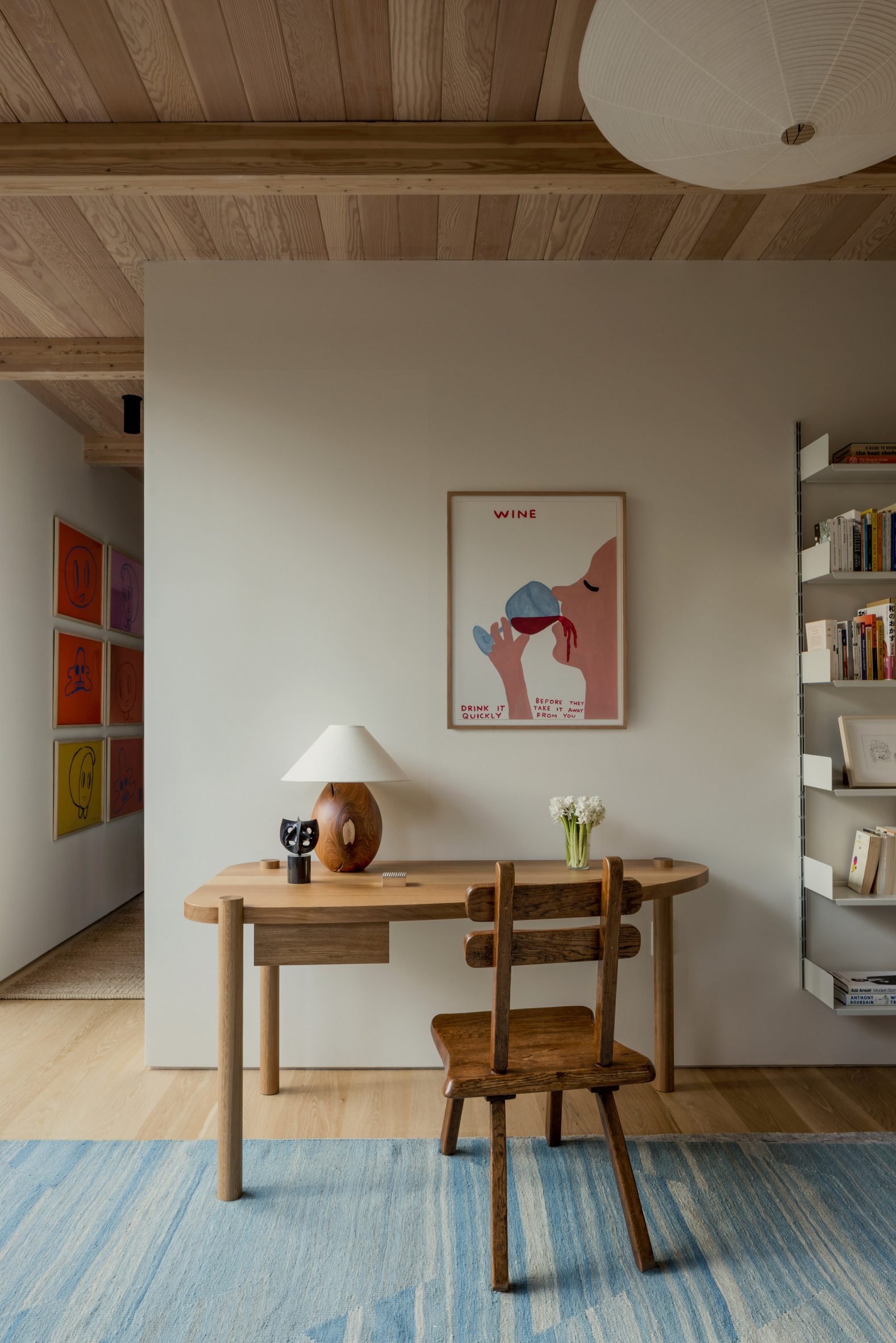 Work space with desk, chair and various artwork