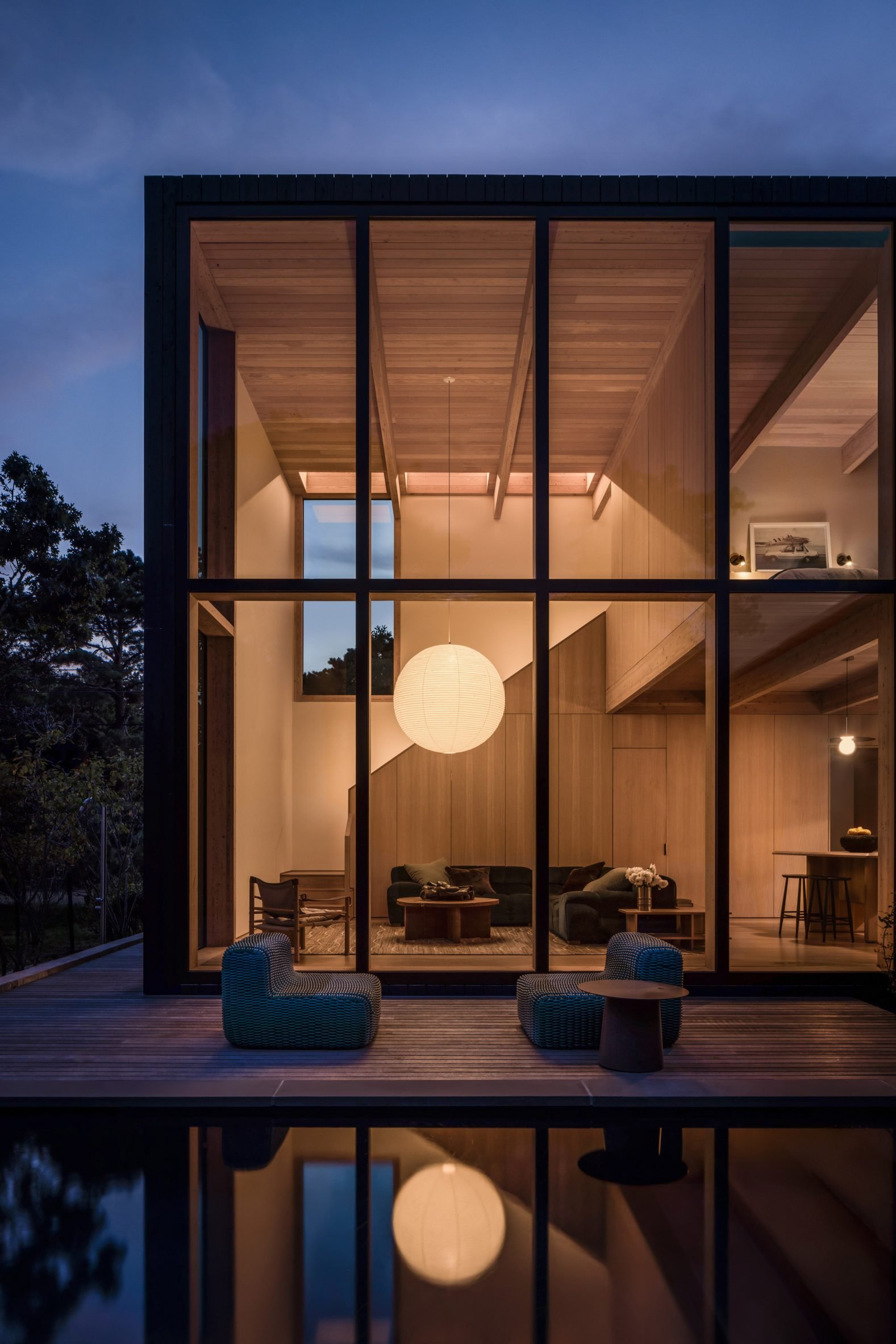 Spherical paper lantern glows through large windows