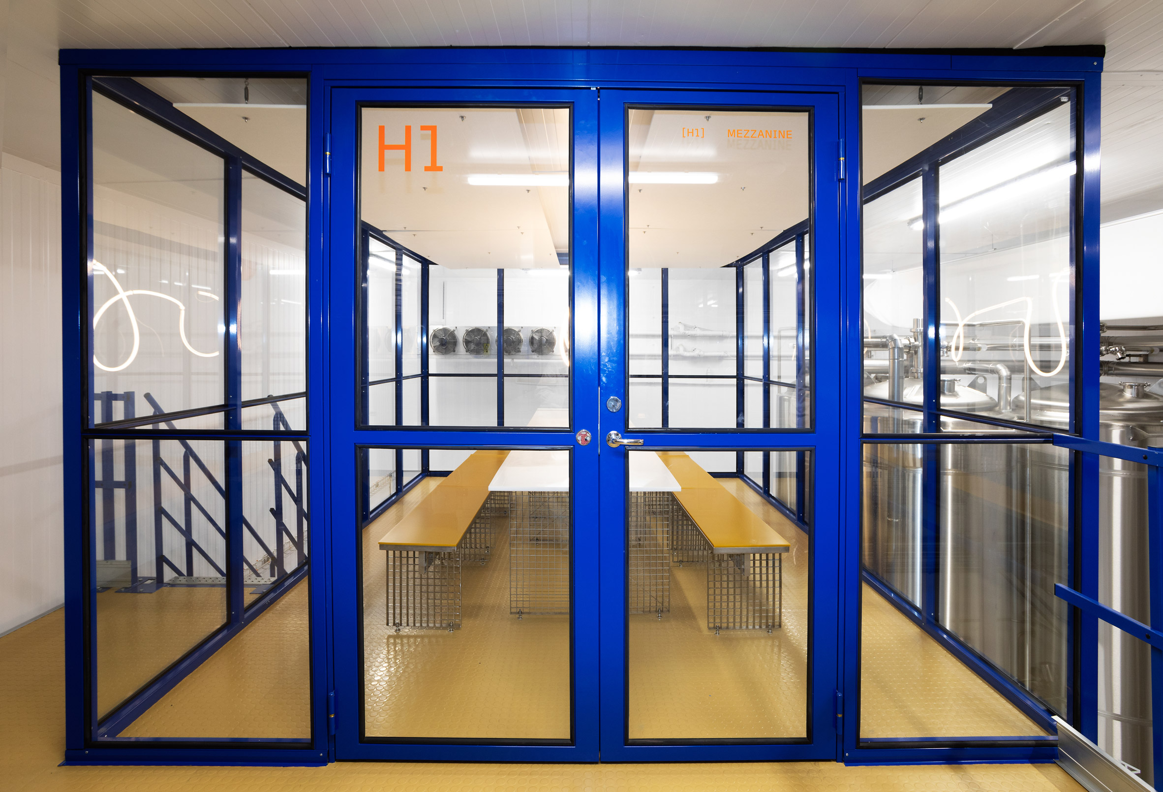 Mezzanine within rectilinear glass and blue-rimmed cube