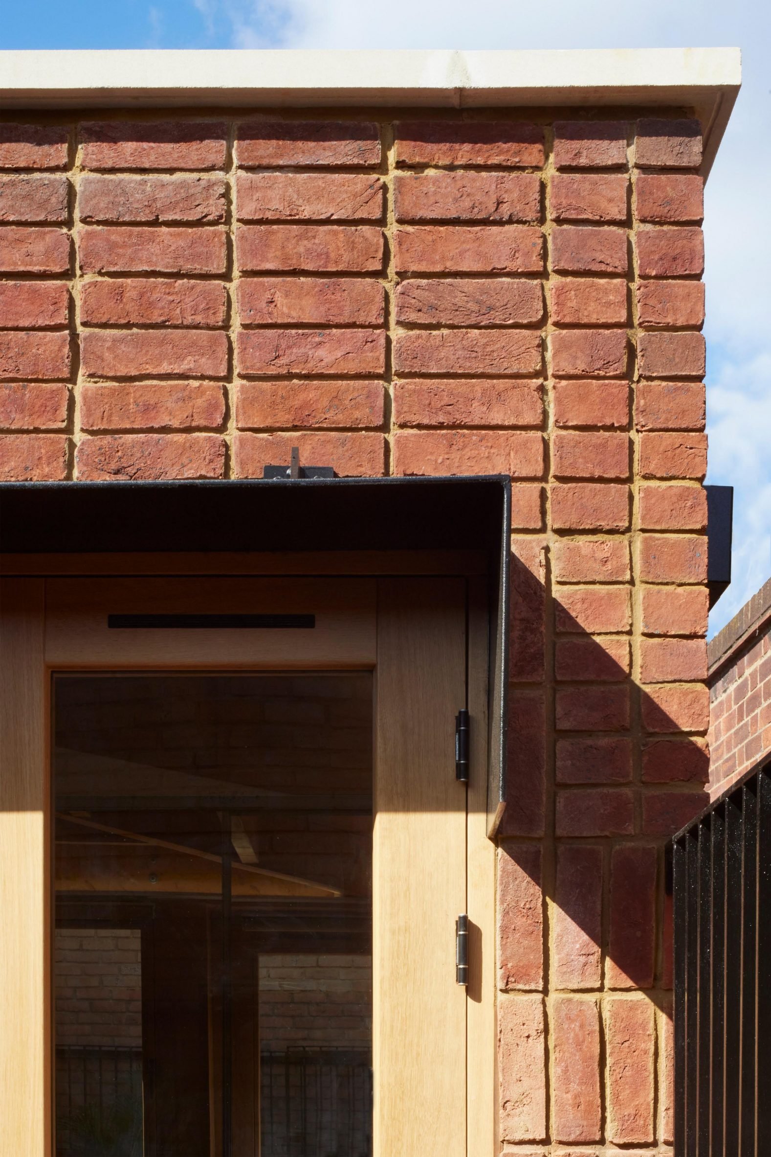 Close up of red handmade bricks and oak doors