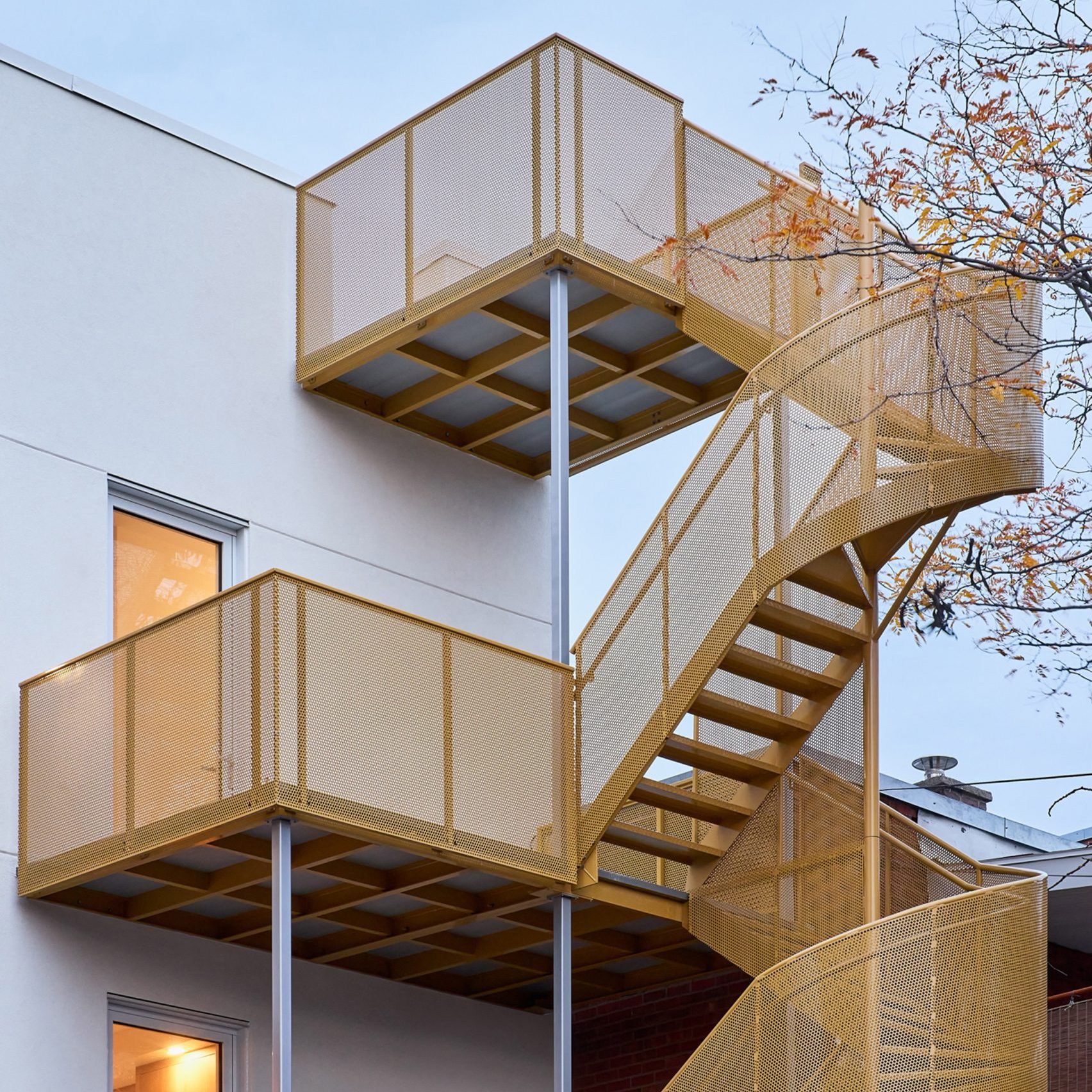 Yellow exterior staircase on apartment block