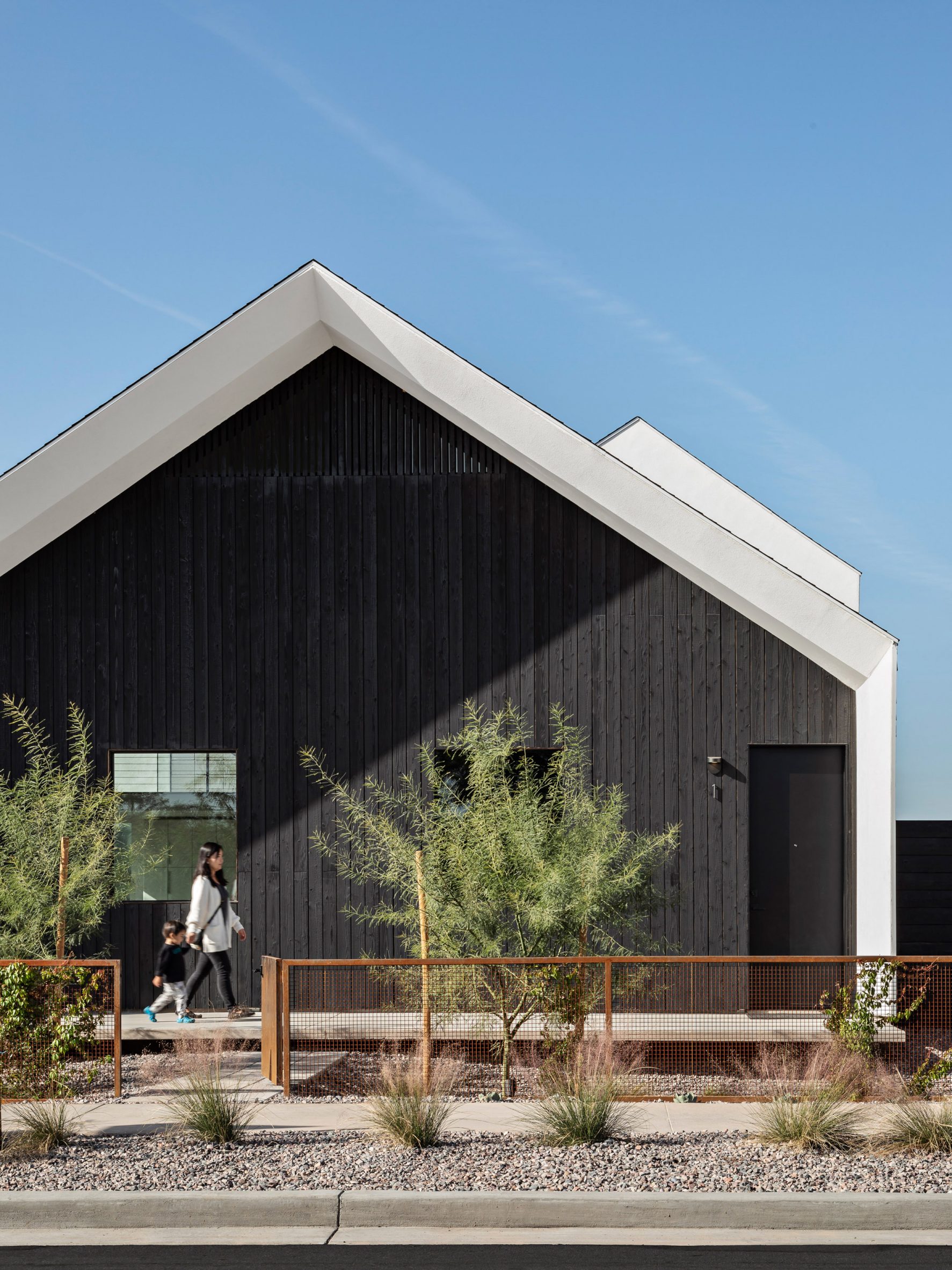 Gable end of a Phoenix house clad in black timber by SinHei Kwok
