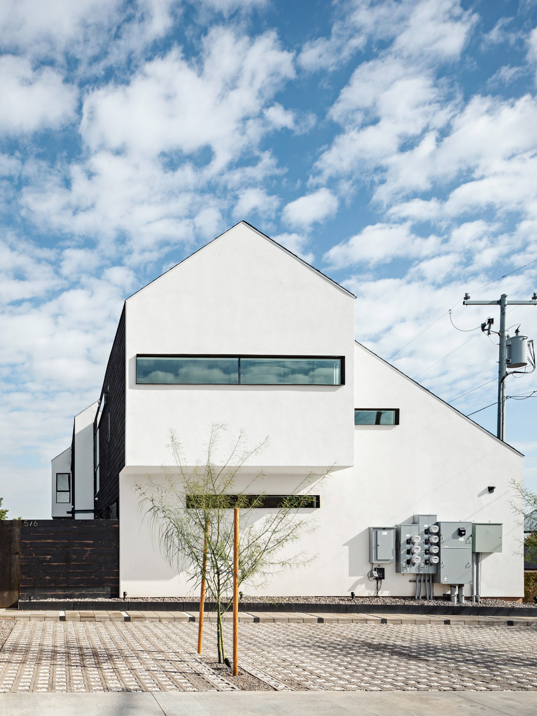 Pitched roof house with extruded upper level and white gable end