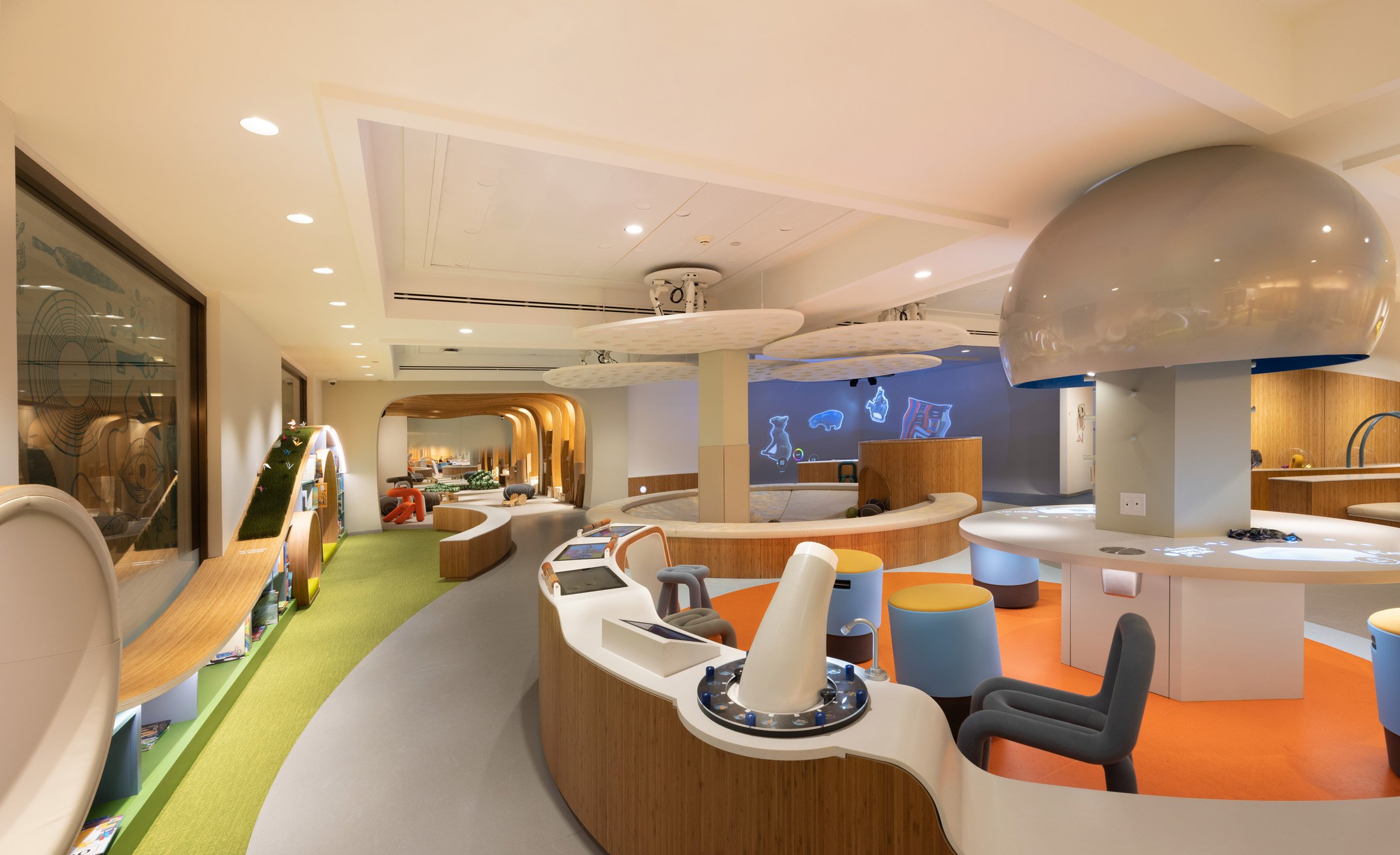 A playroom for children with bright carpeting and curving furniture