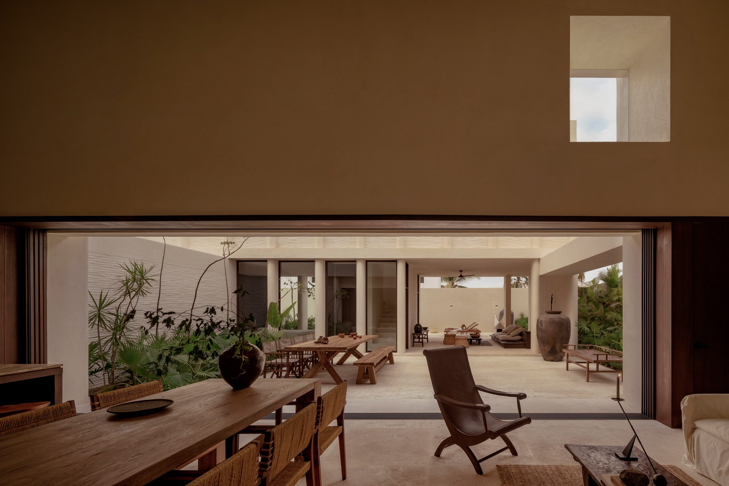 View from living room through retracted glass doors to a coutyard