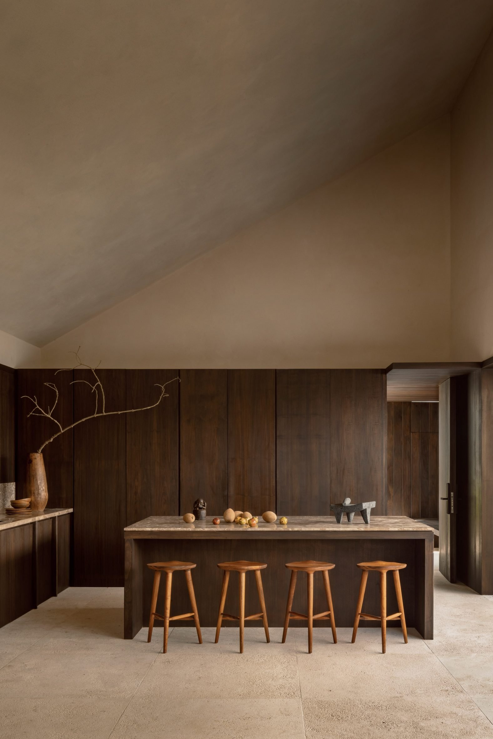 Minimalist kitchen with wood panelling and sloped plaster ceiling