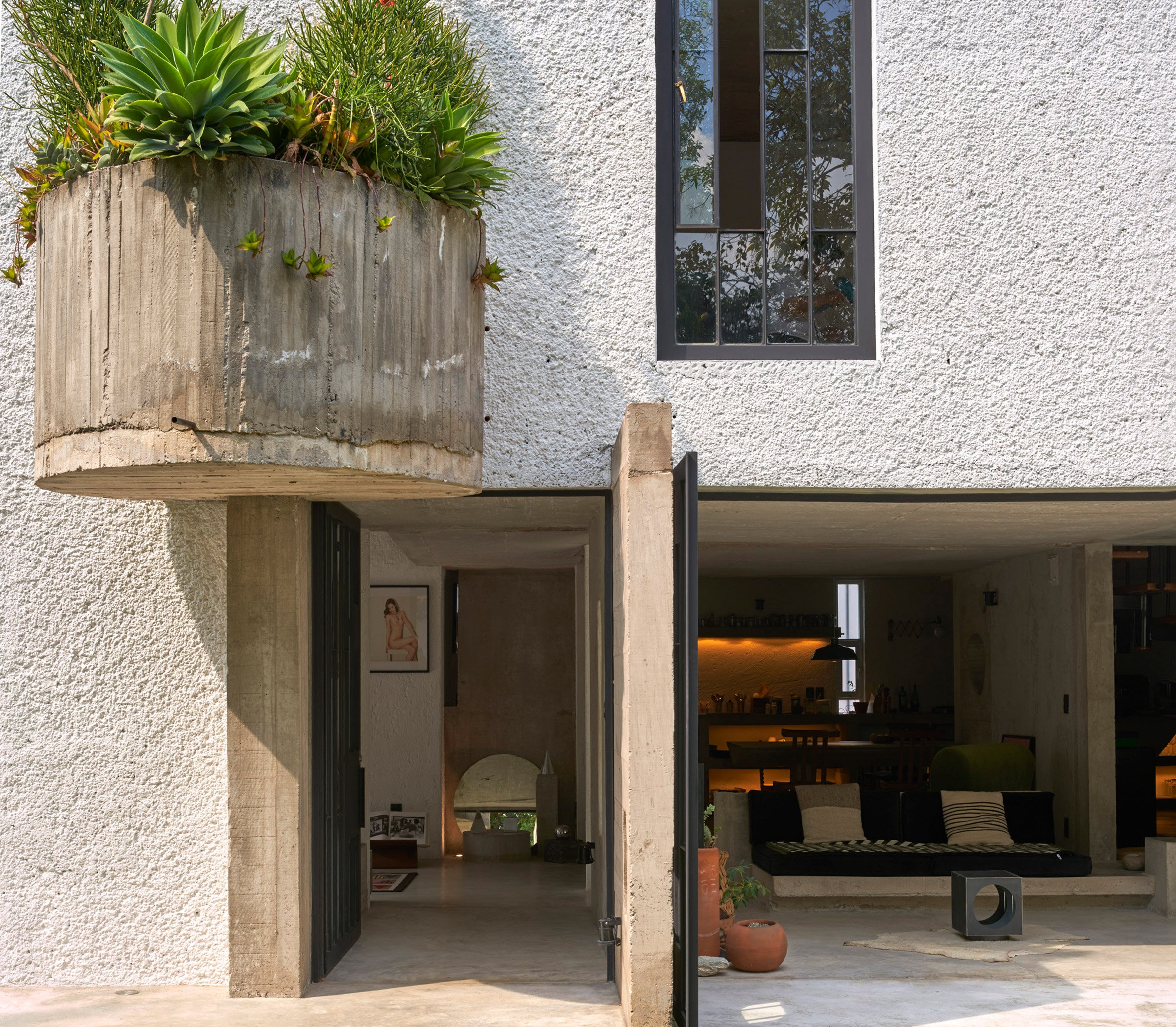 A large semi-circle planter attached to the exterior of a house