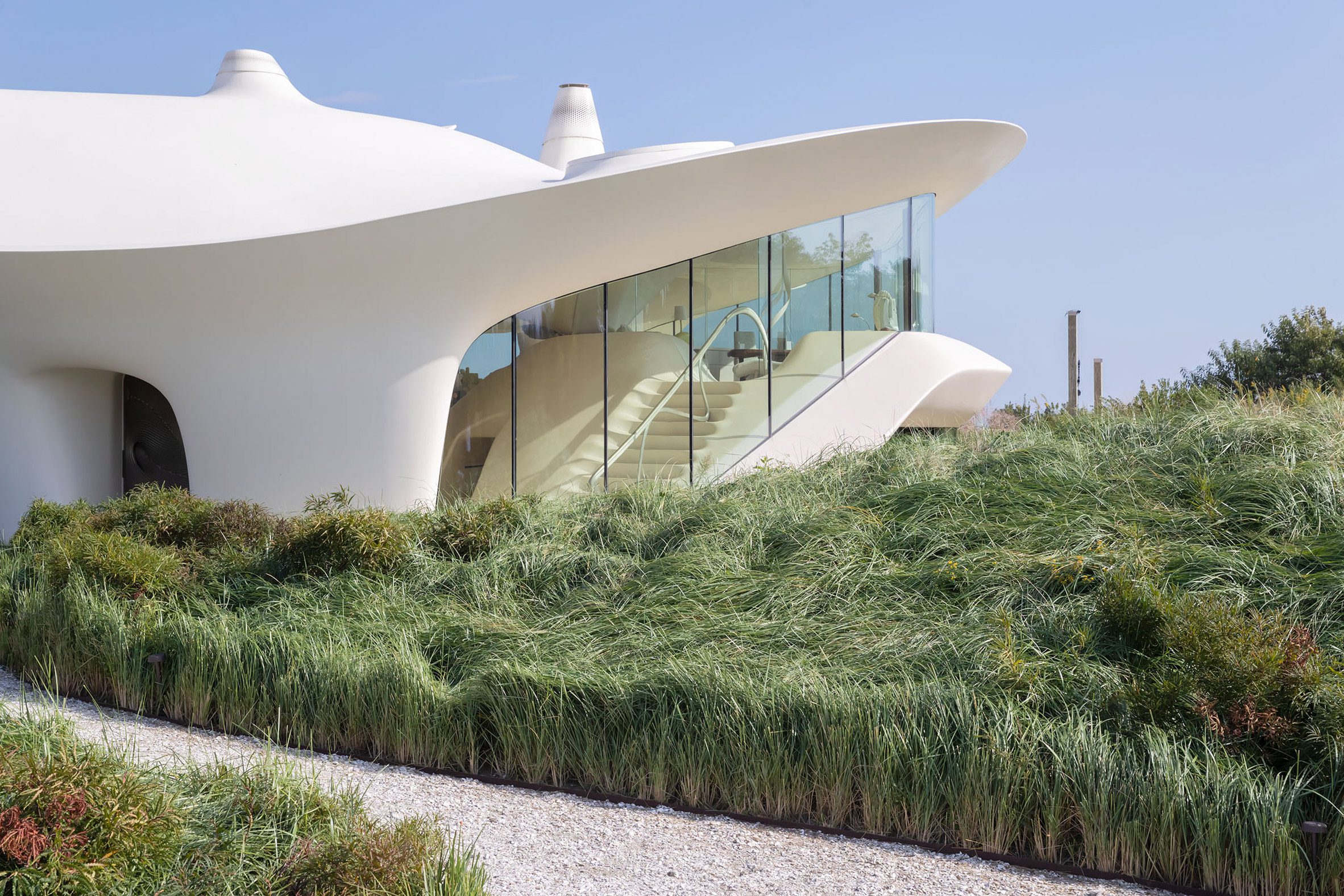 Glass window in modern home with beach tall grass