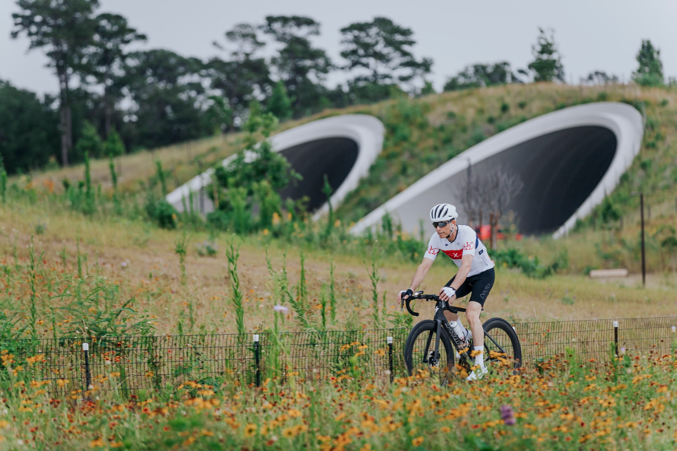 A biker biking past tunnels