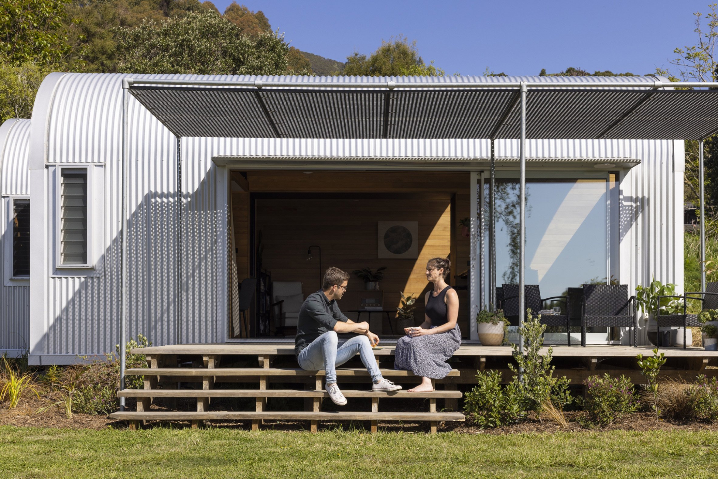 Photo of people sat outside the home