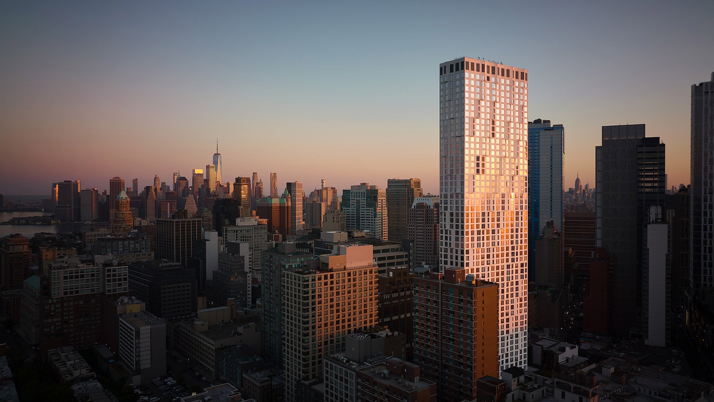 11 Hoyt skyscraper recflecting the sunset with downtown brooklyn in background