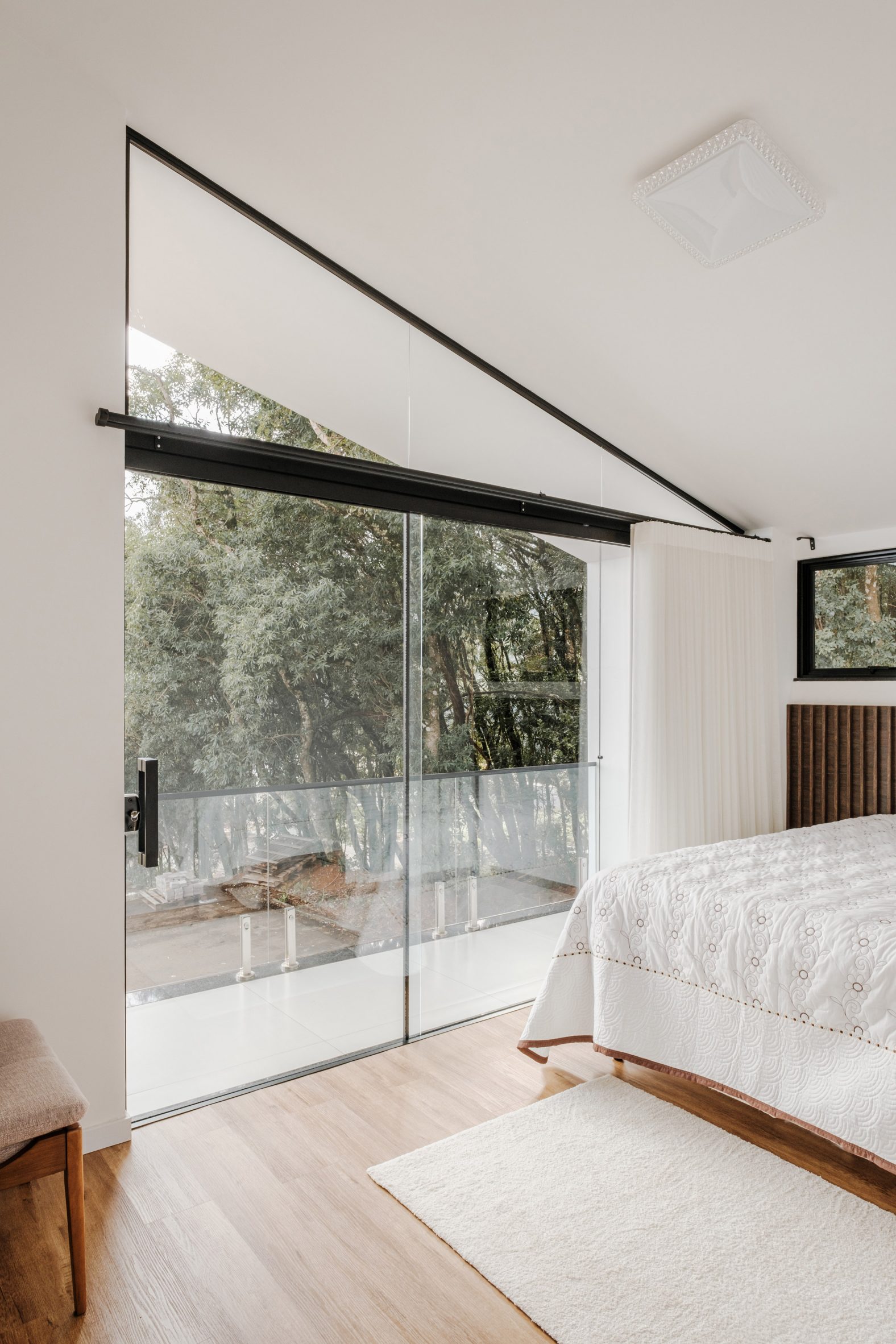 Neutral-hued bedroom within house by Studio Kunz